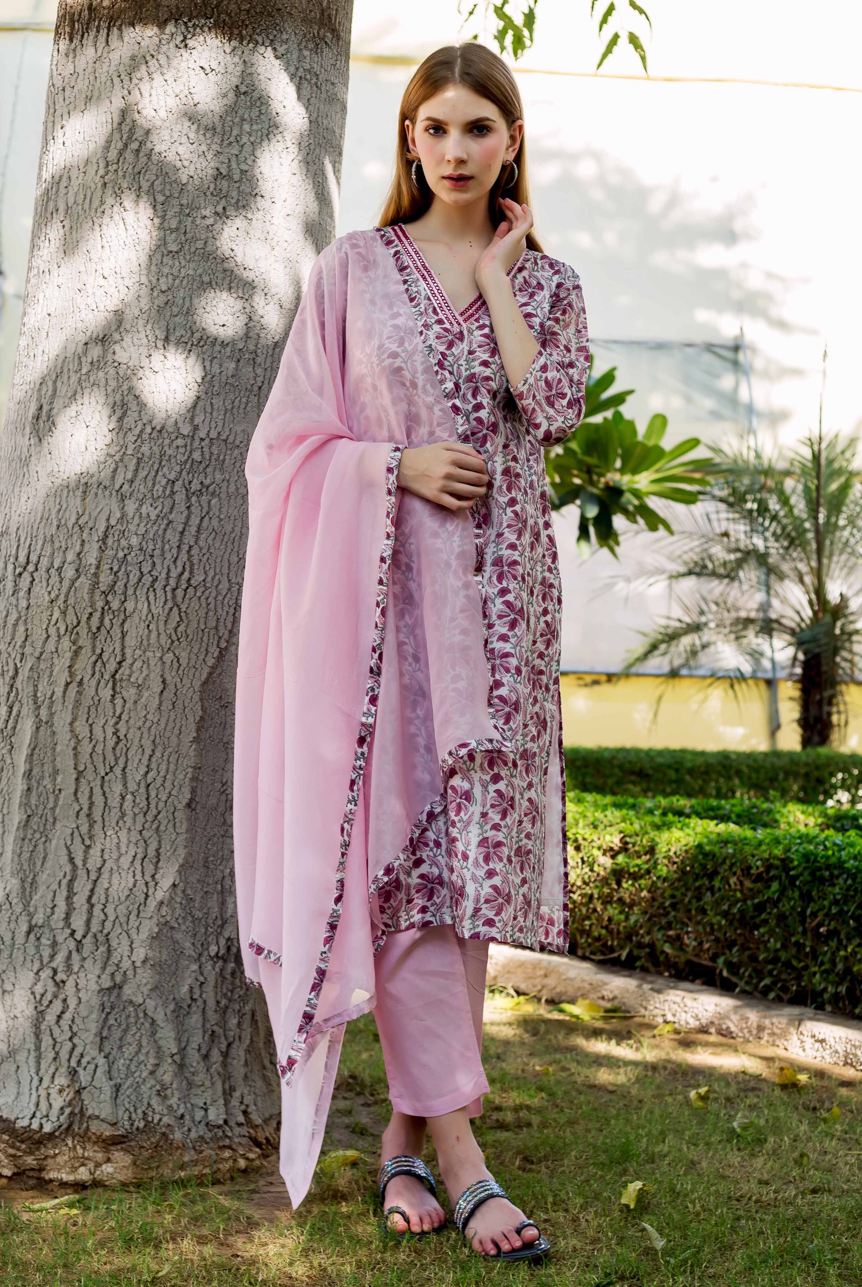 Full shot of a model wearing a pink hand-block-printed kurta set with maroon floral print.