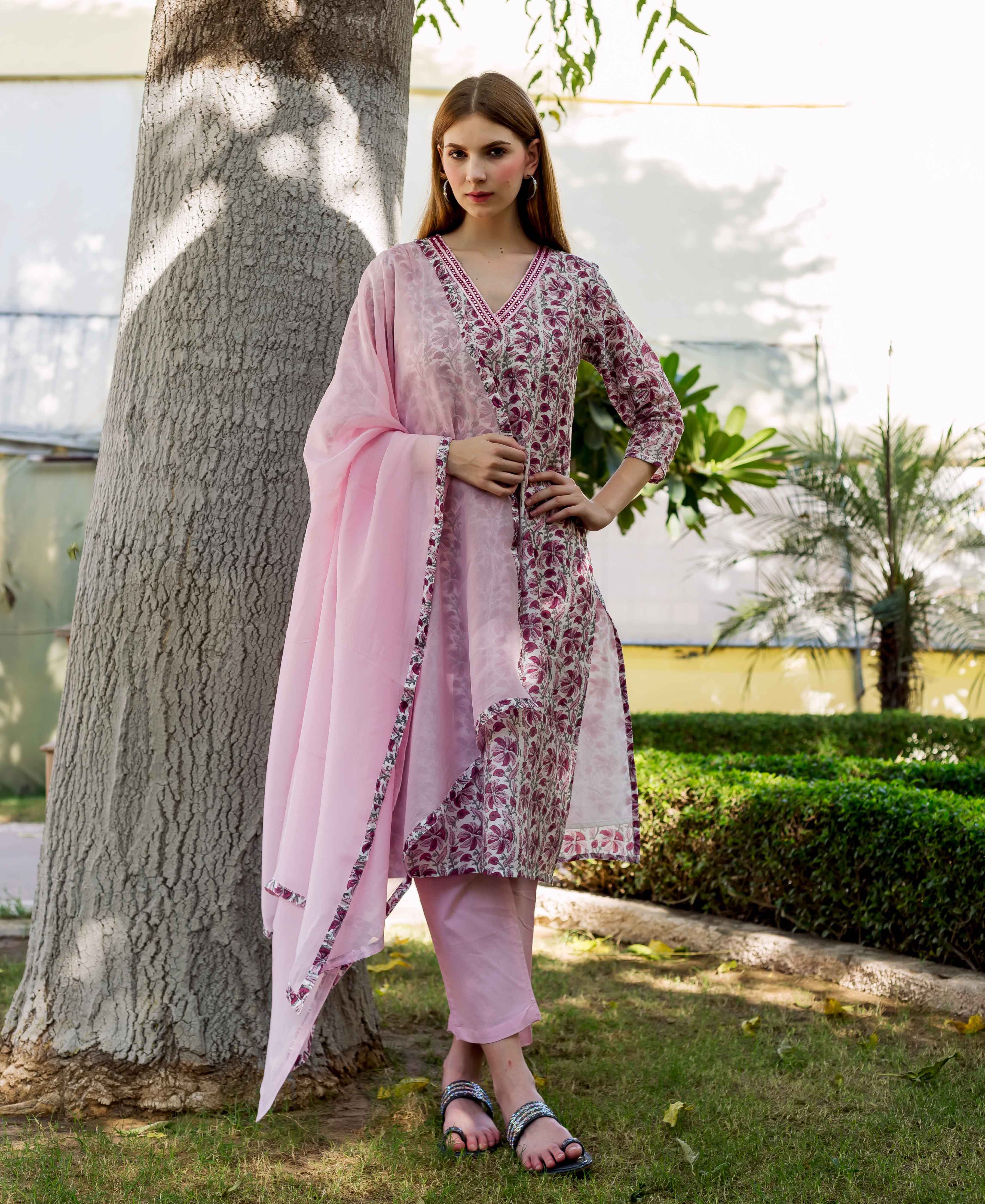 Model wearing a pink ethnic hand-block-printed kurta set with matching pants and dupatta.