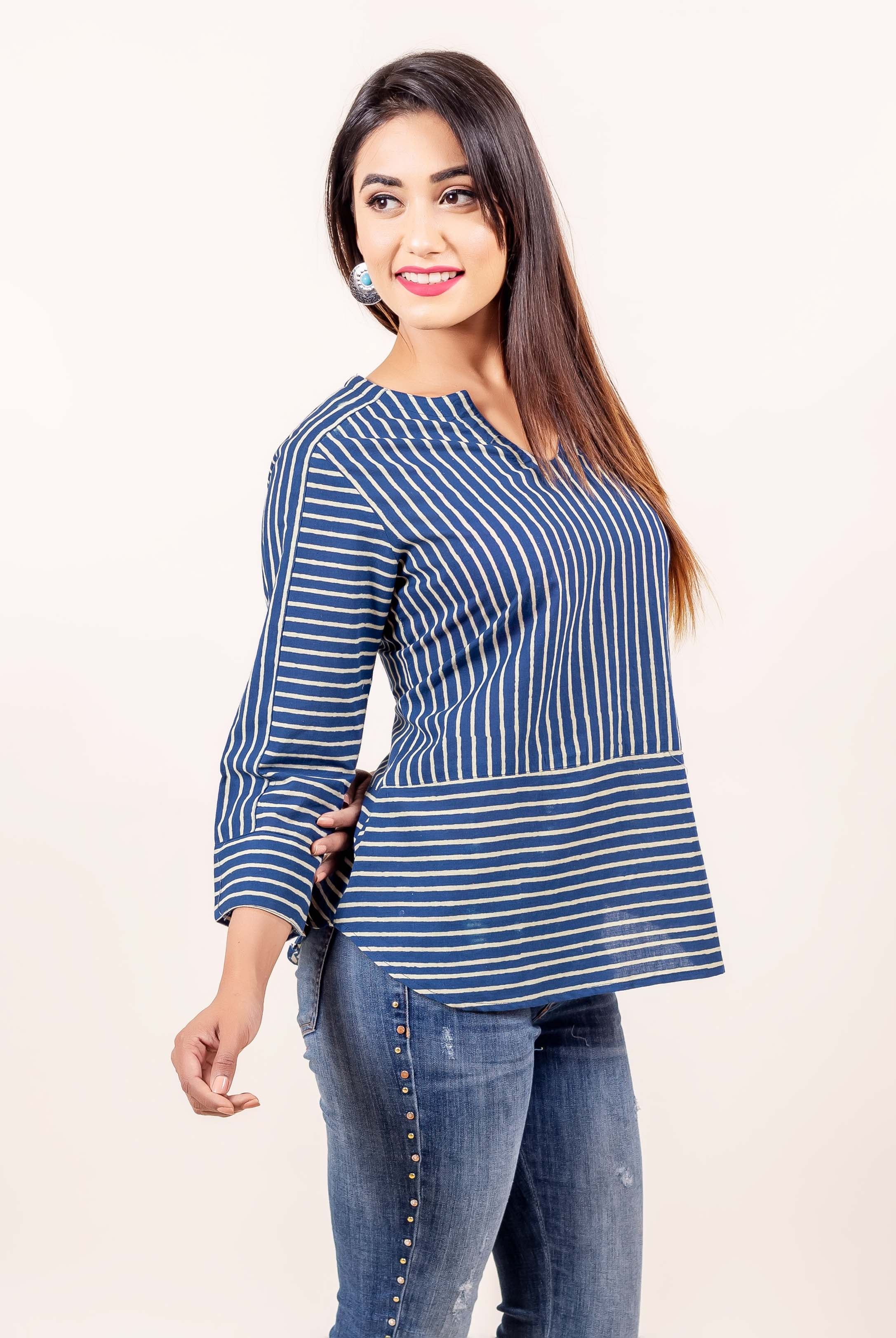 Side view model in indigo and cream hand block printed cotton top with varied stripes.