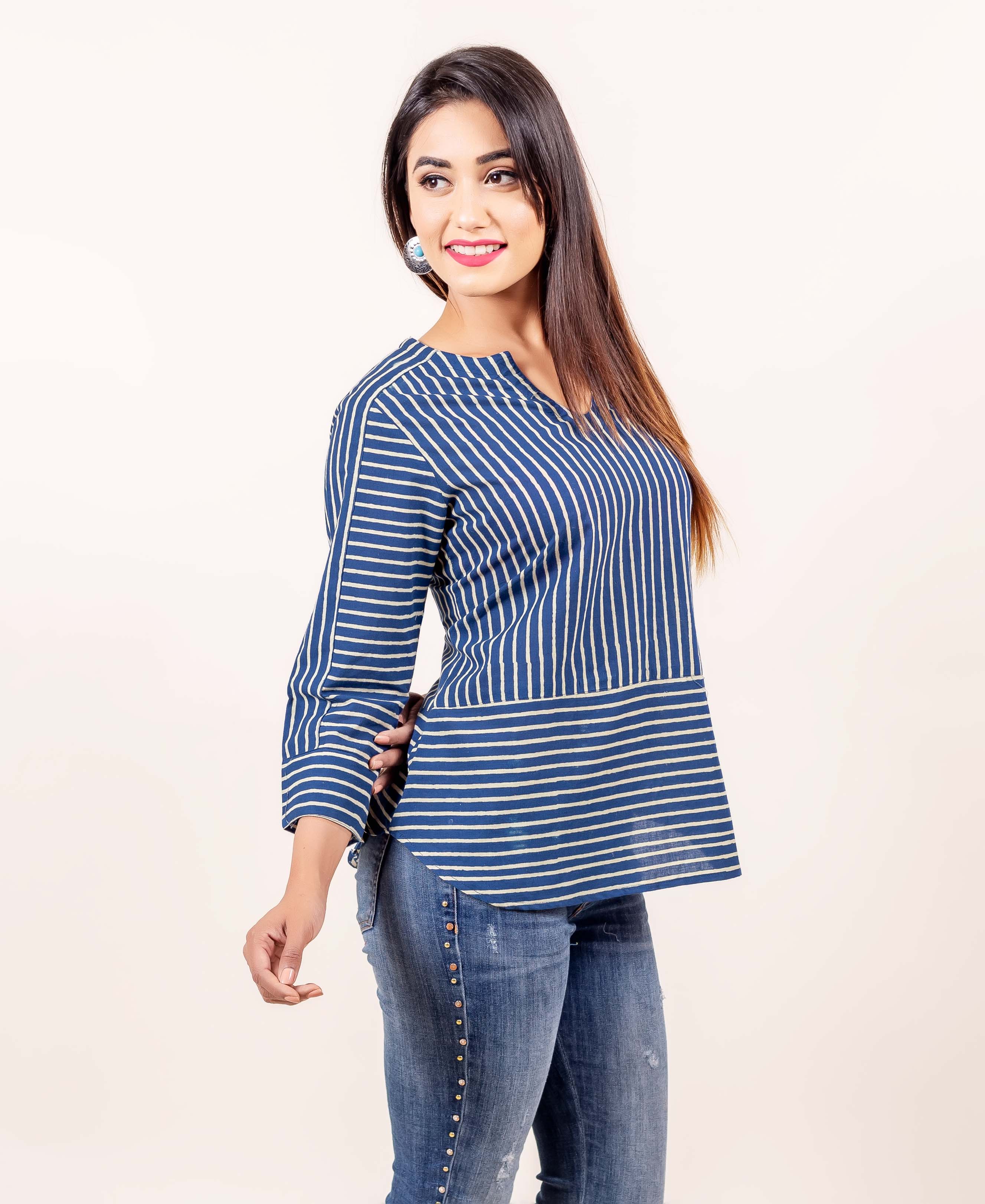 Side view model in indigo and cream hand block printed cotton top with varied stripes.