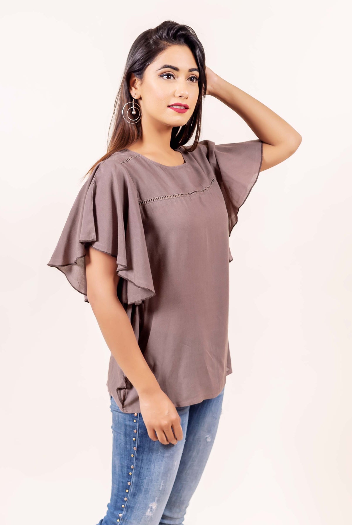 Brown bell sleeves top with hand-block print on a model.