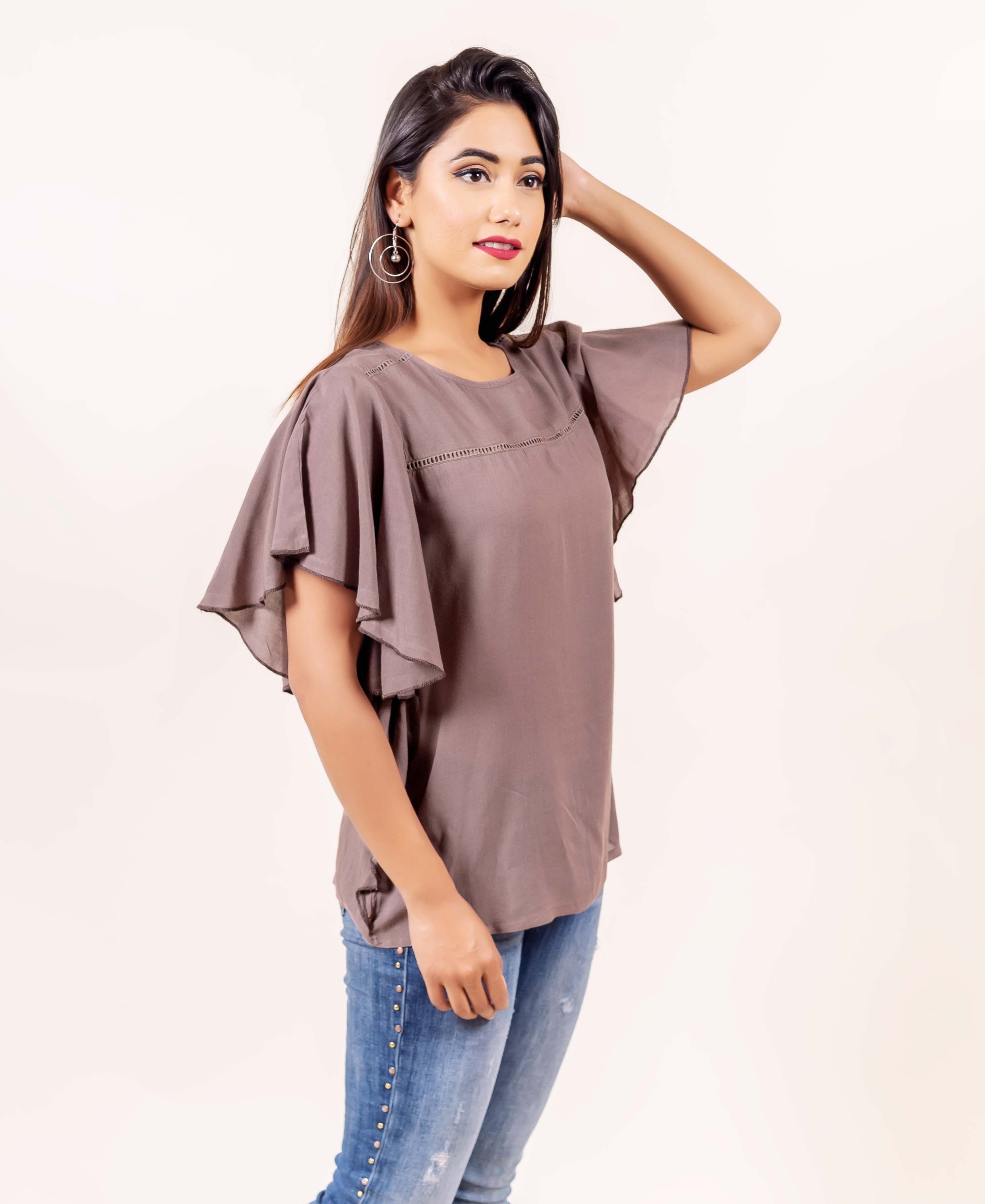 Brown bell sleeves top with hand-block print on a model.