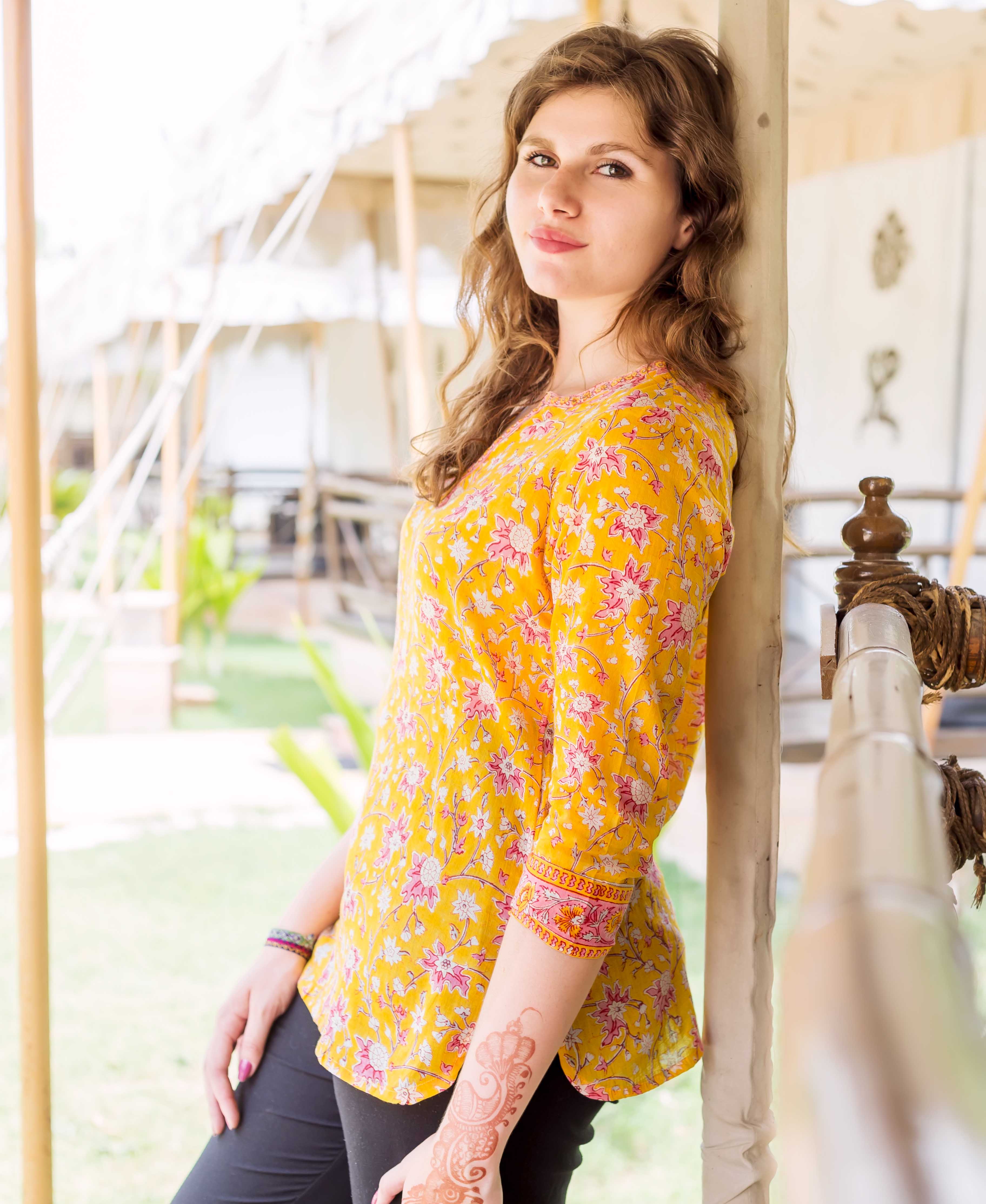 Model in a yellow and pink floral hand block printed ethnic top with misprint details.