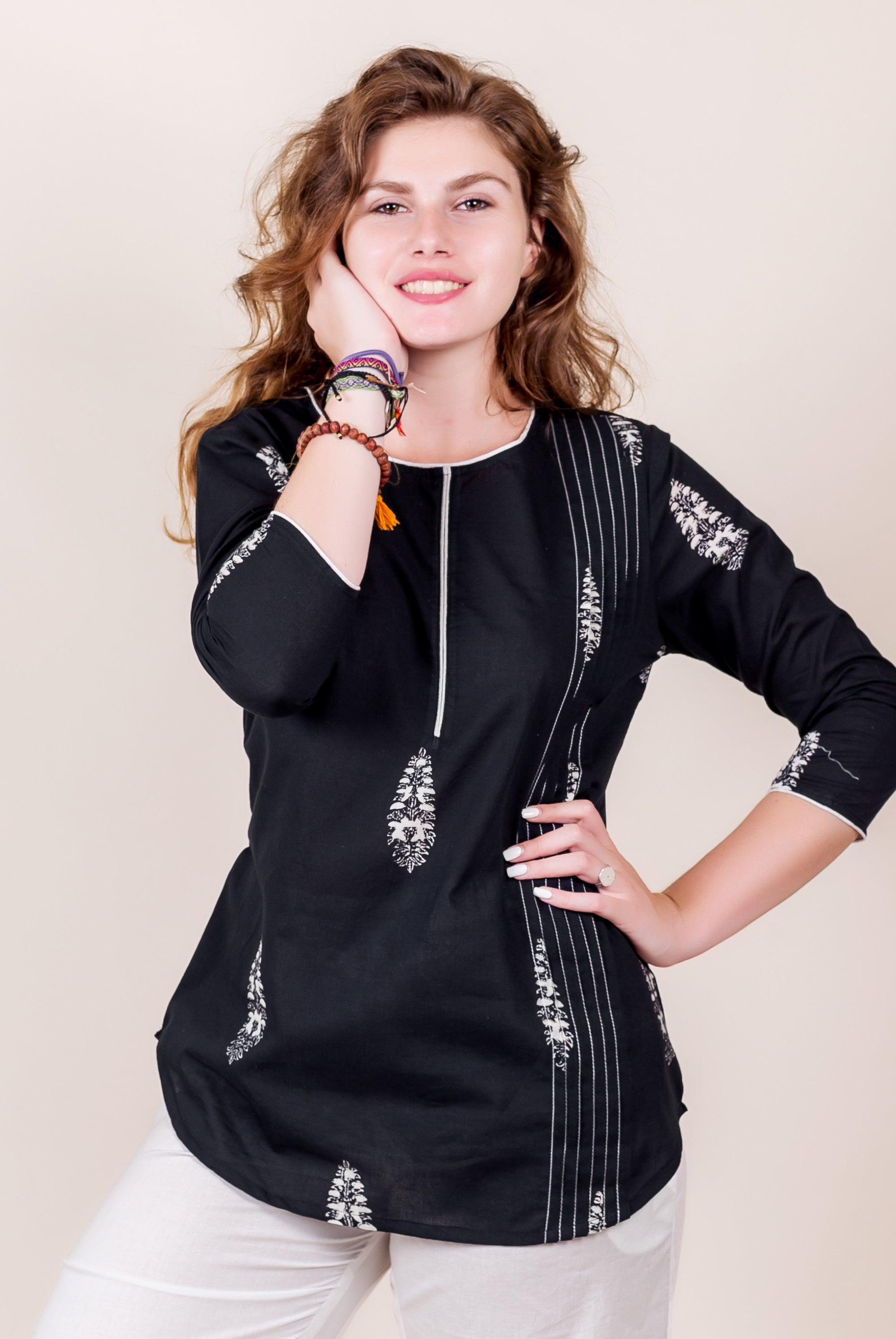 Front view of black cotton top with white hand-block ethnic print on model.