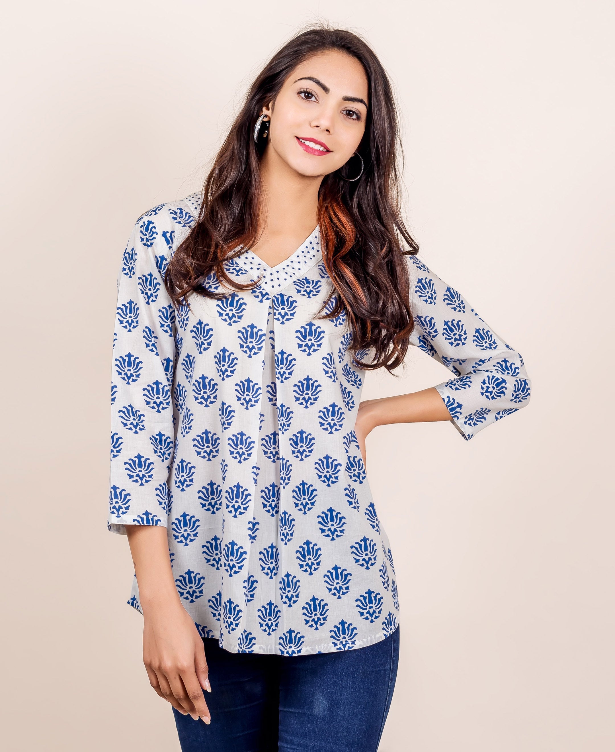 A model wearing a white and blue hand block printed V-neck top.