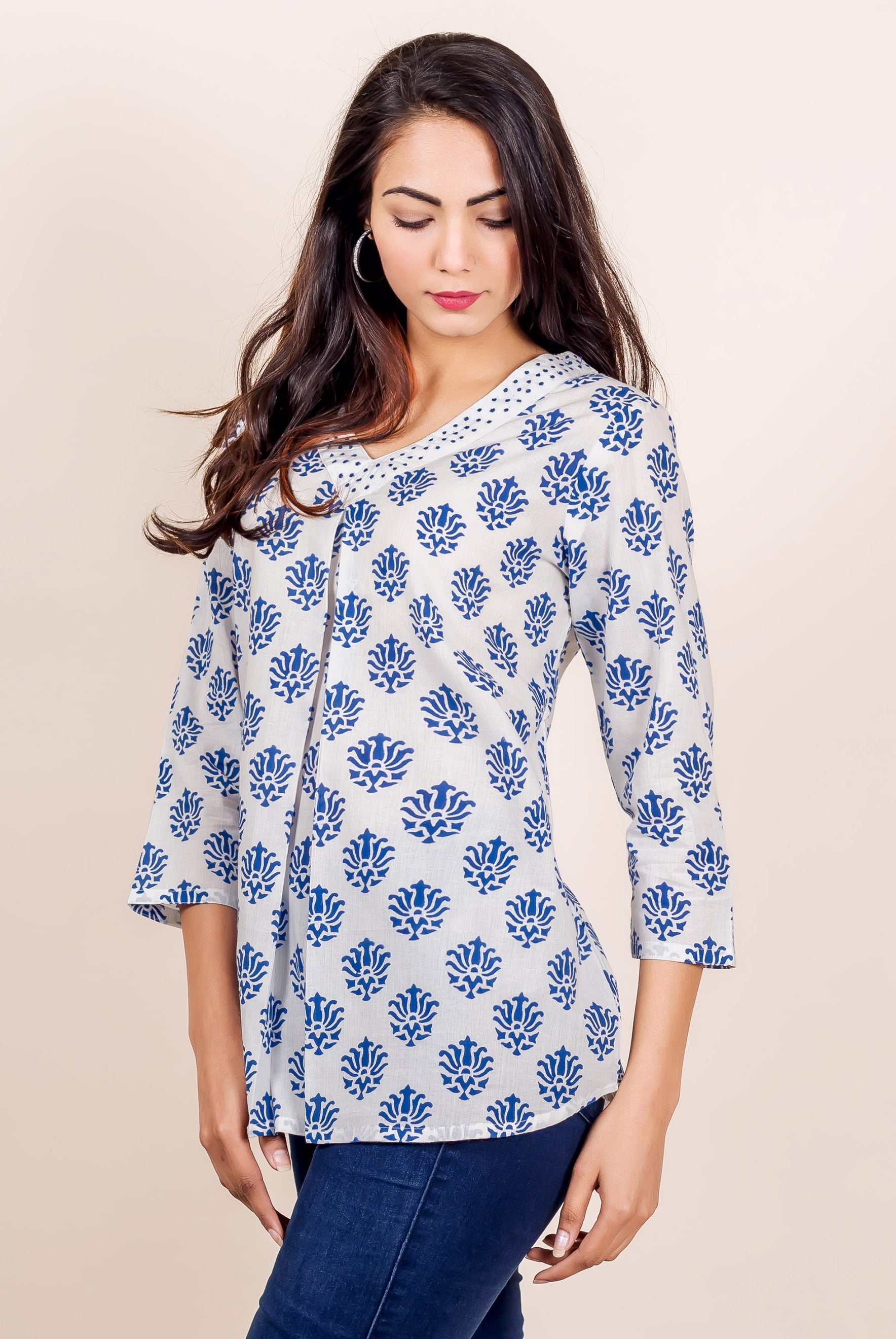 White and blue hand block printed V-neck top with floral pattern on a model.