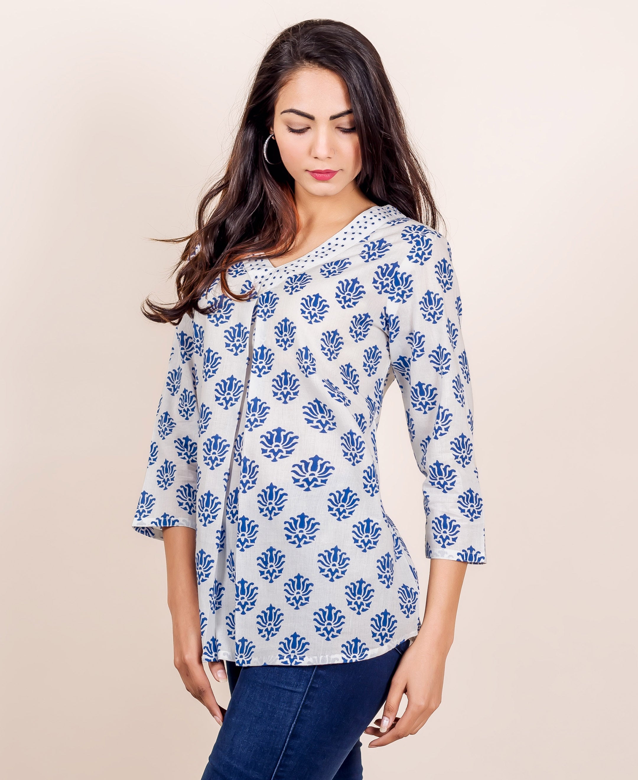 White and blue hand block printed V-neck top with floral pattern on a model.