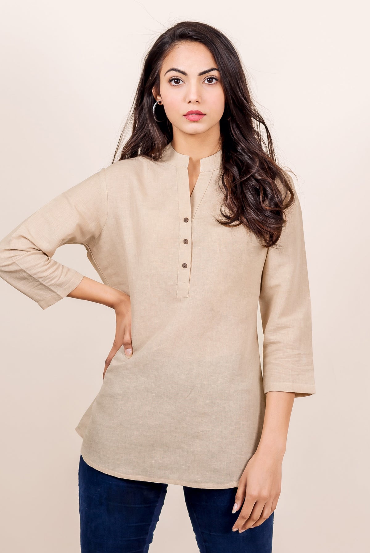 A model wearing a beige linen top with a split mandarin collar.