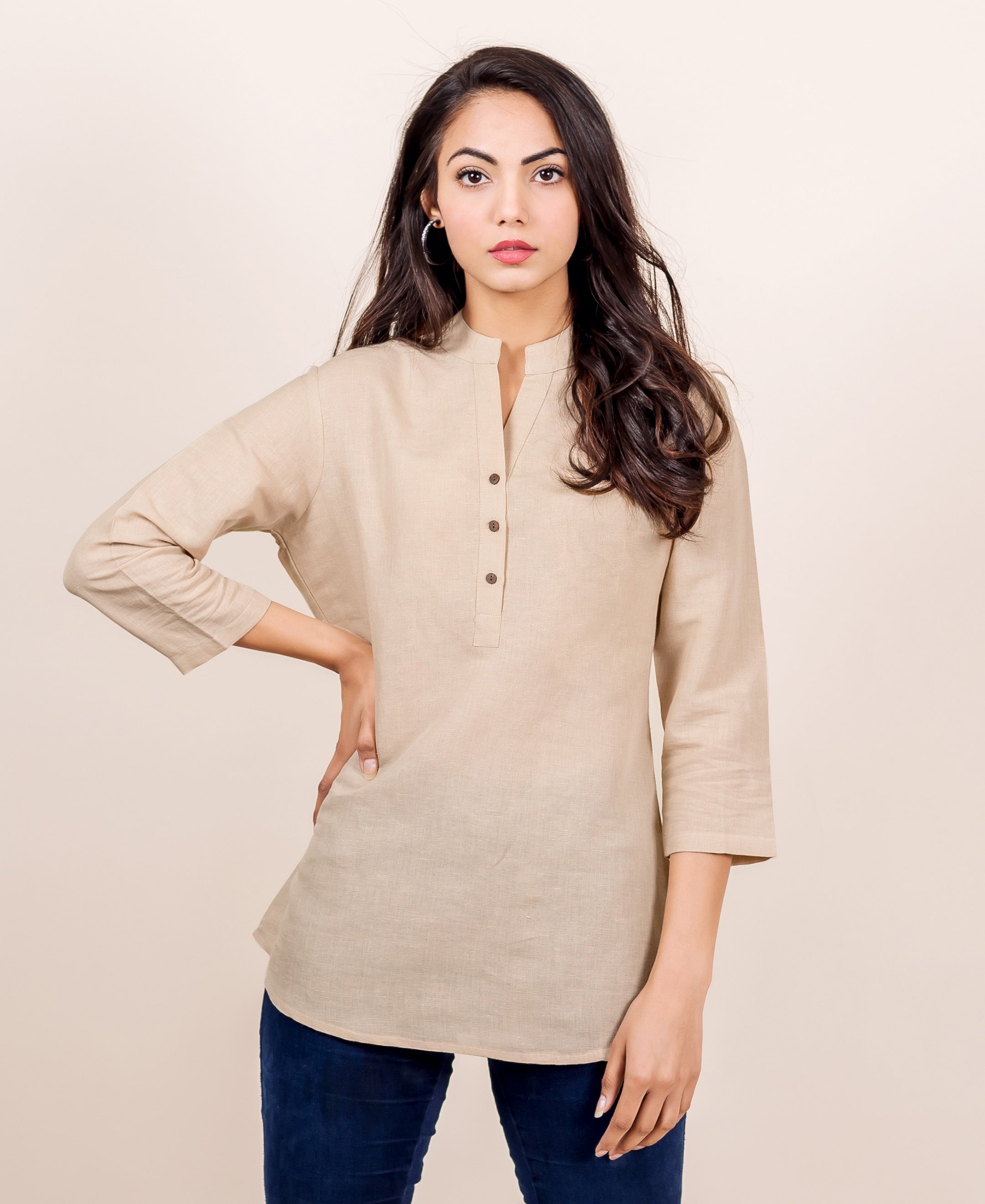 A model wearing a beige linen top with a split mandarin collar.