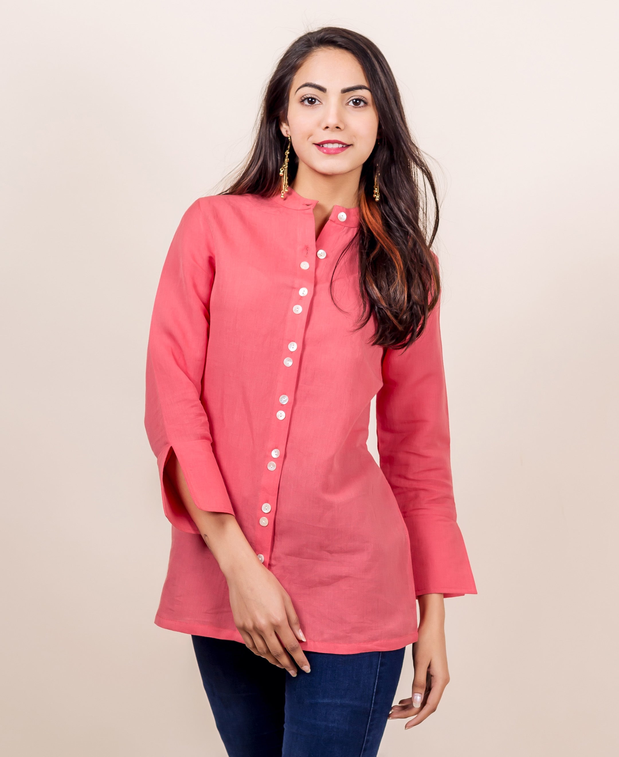 Model wears a peach linen top, buttoned-down, with 3/4 sleeves and band collar.