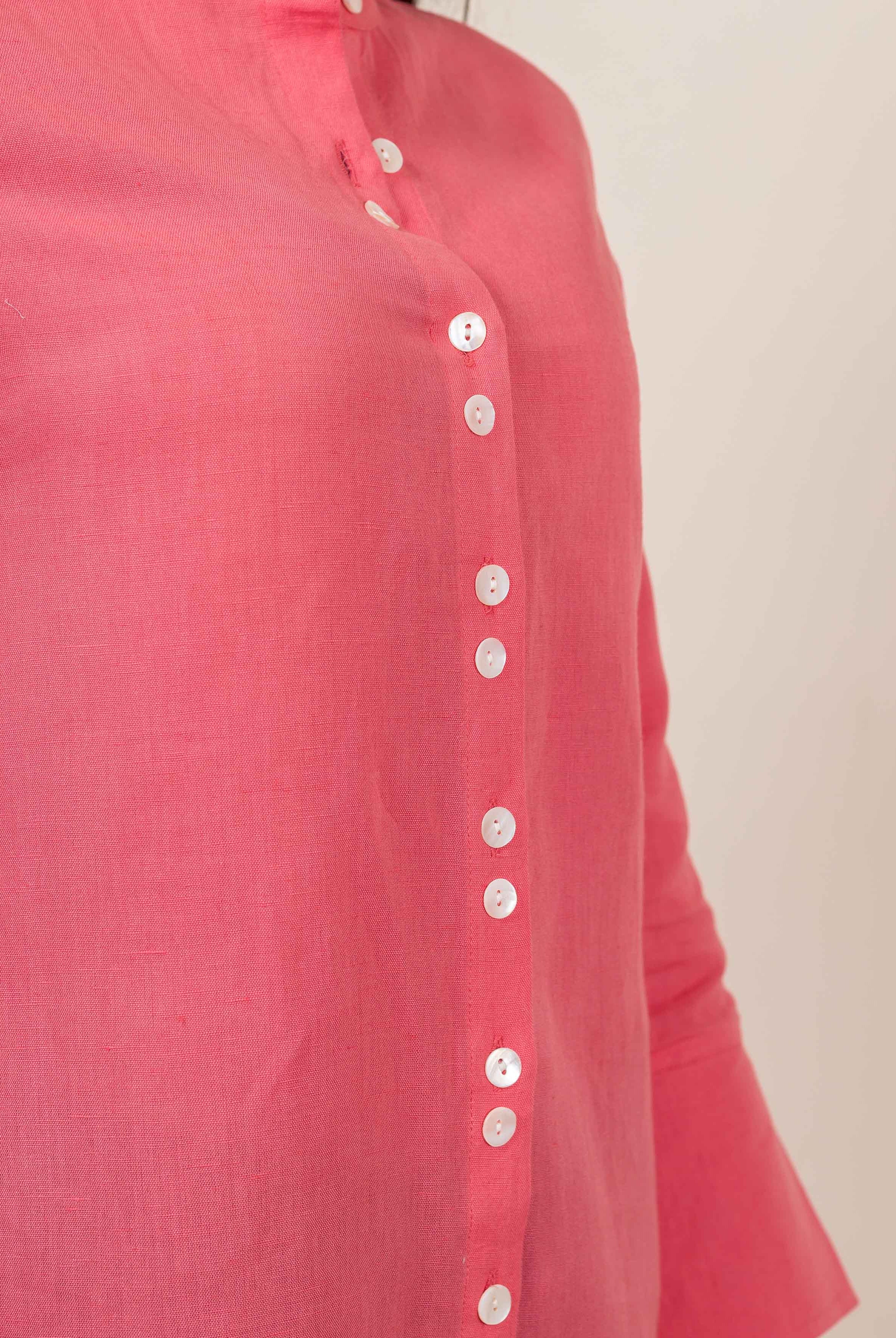 Peach linen top on a model, featuring a band collar and white button-down placket.