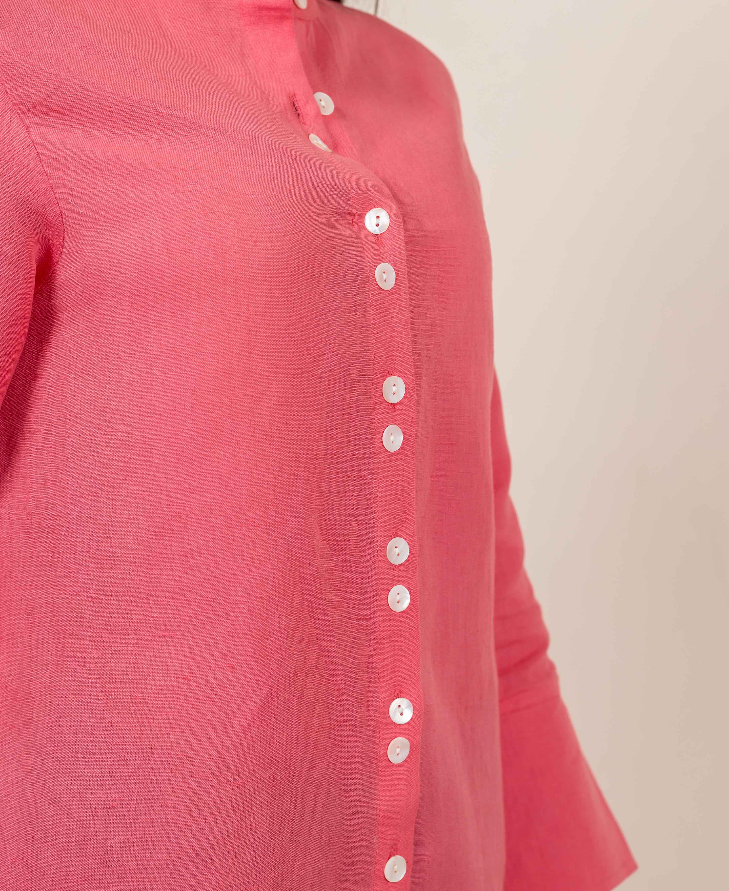 Peach linen top on a model, featuring a band collar and white button-down placket.