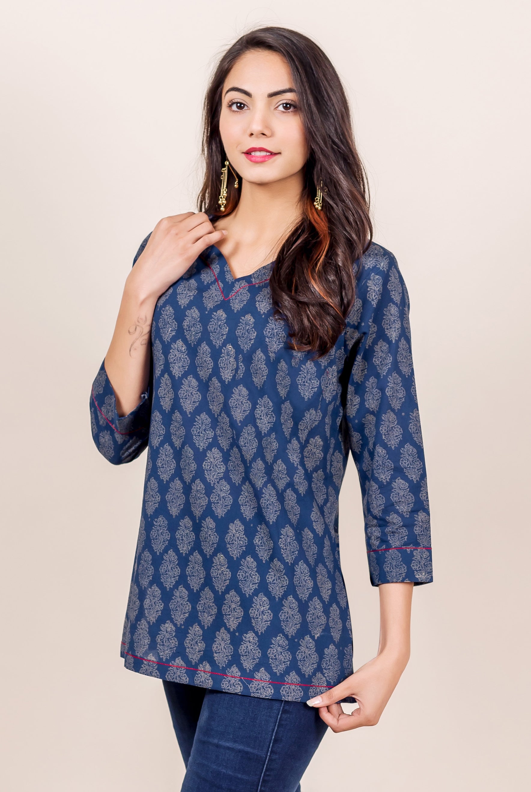 Model wears an indigo hand block printed top featuring red piping detail.