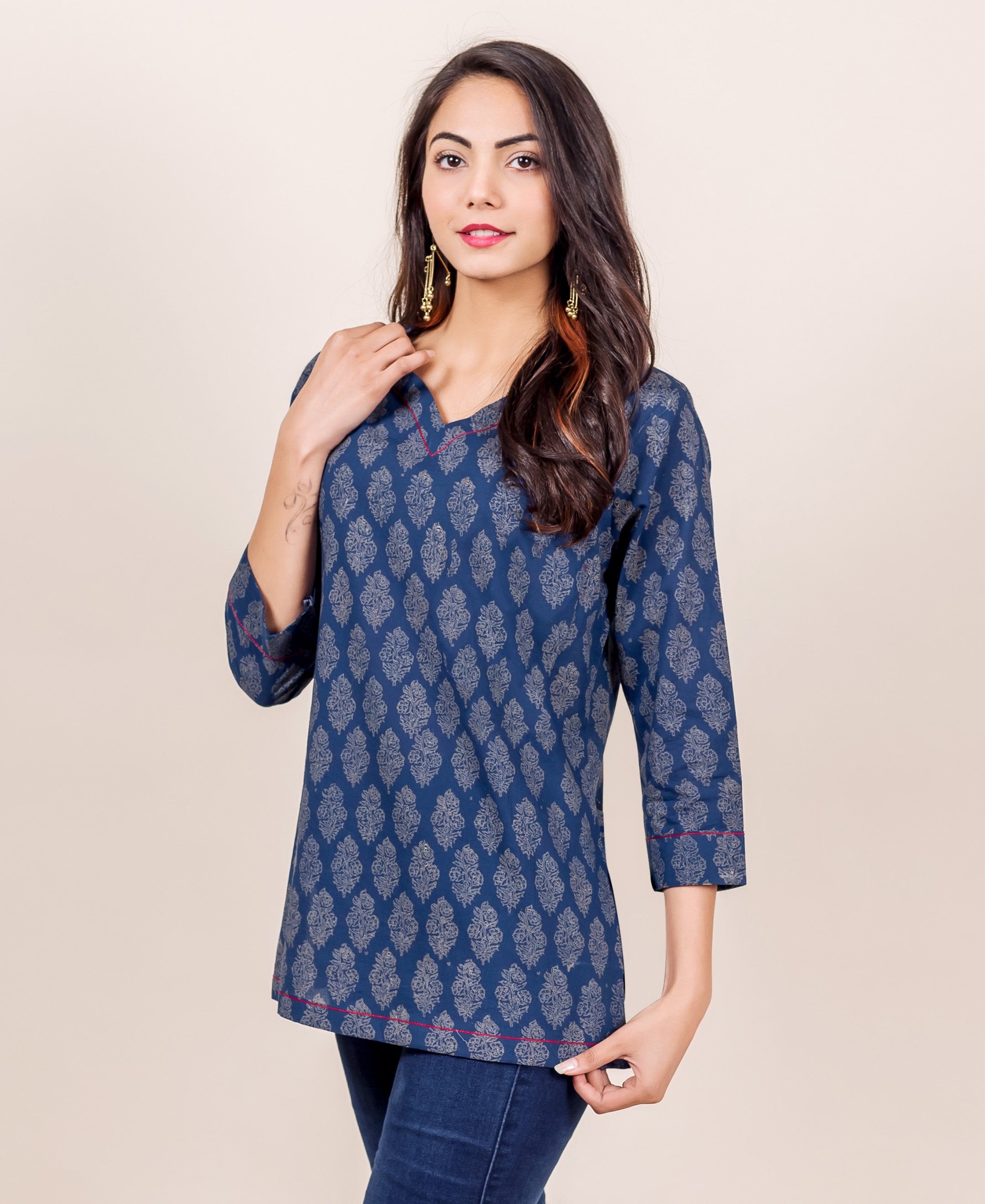 Model wears an indigo hand block printed top featuring red piping detail.