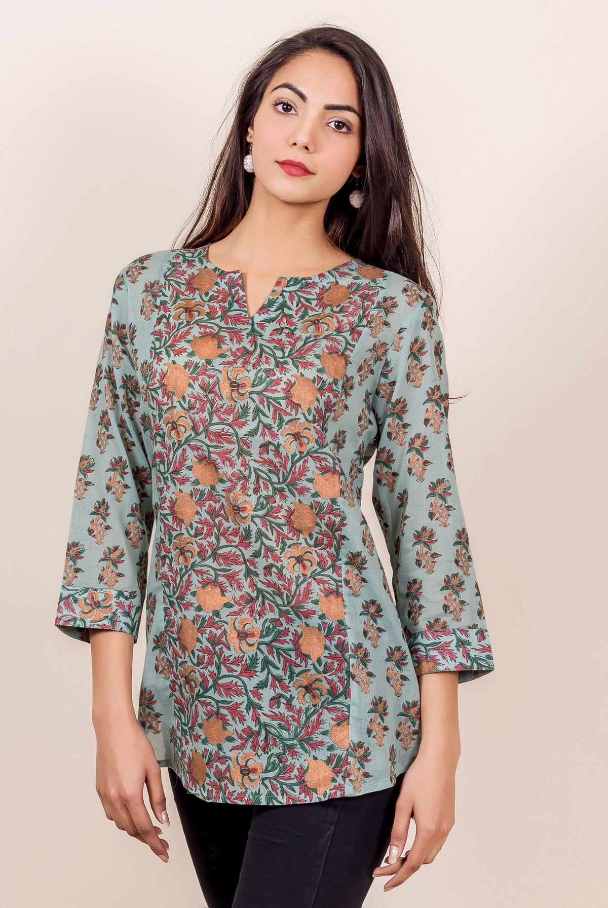 Model in a light blue hand-block printed floral panel top with orange and red designs.
