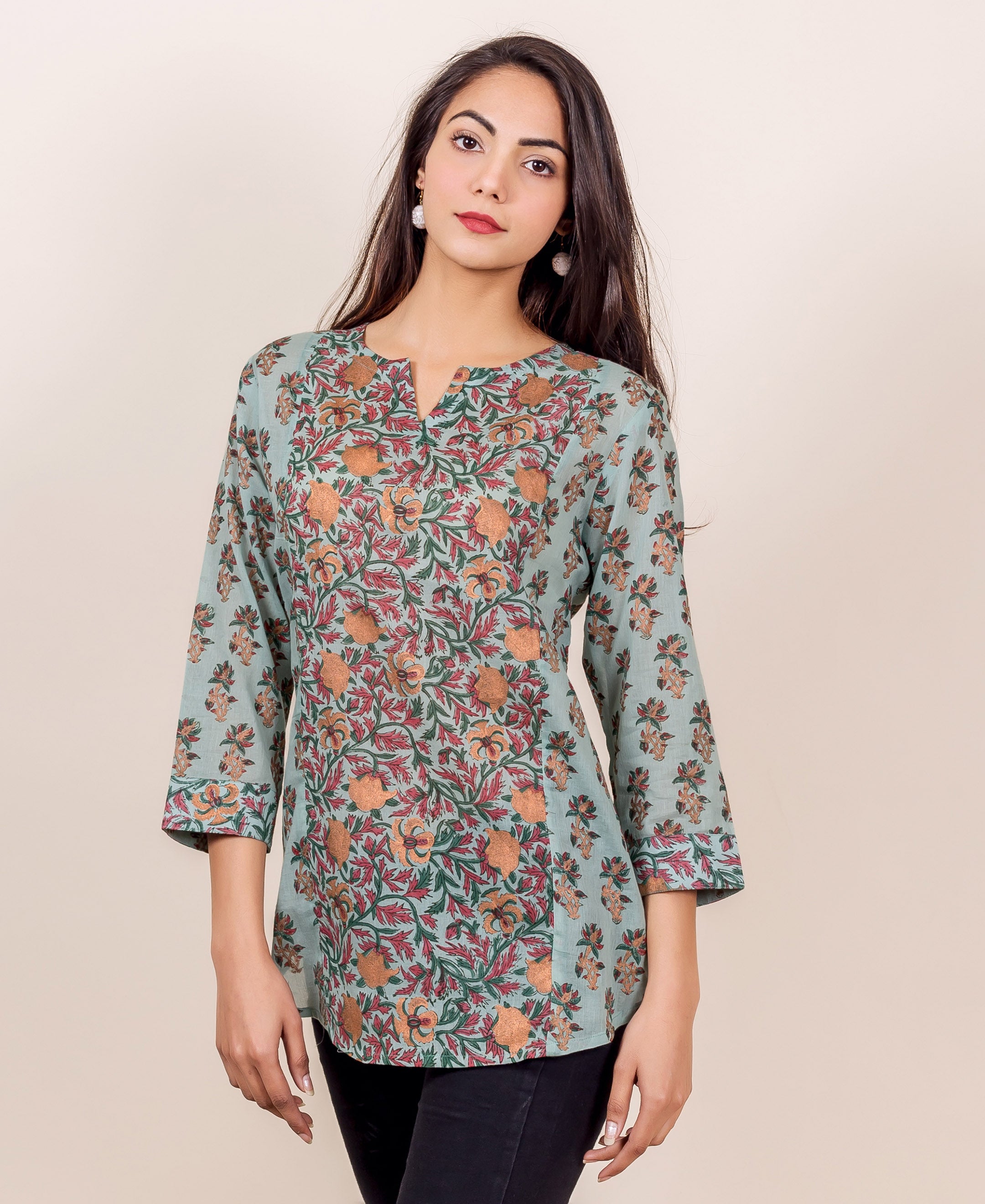 Model in a light blue hand-block printed floral panel top with orange and red designs.