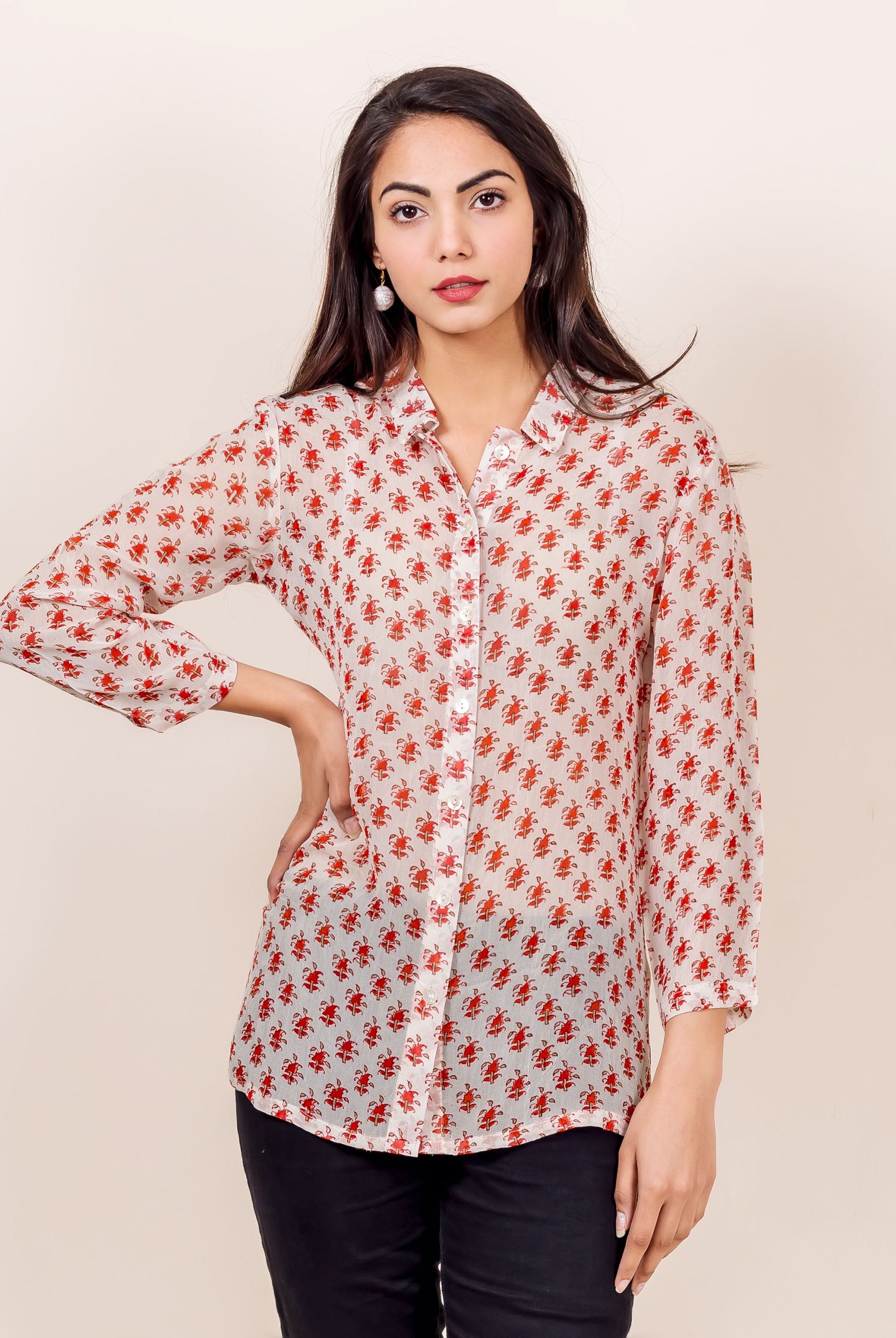 Front view of model in an off-white georgette shirt with small red traditional block print.