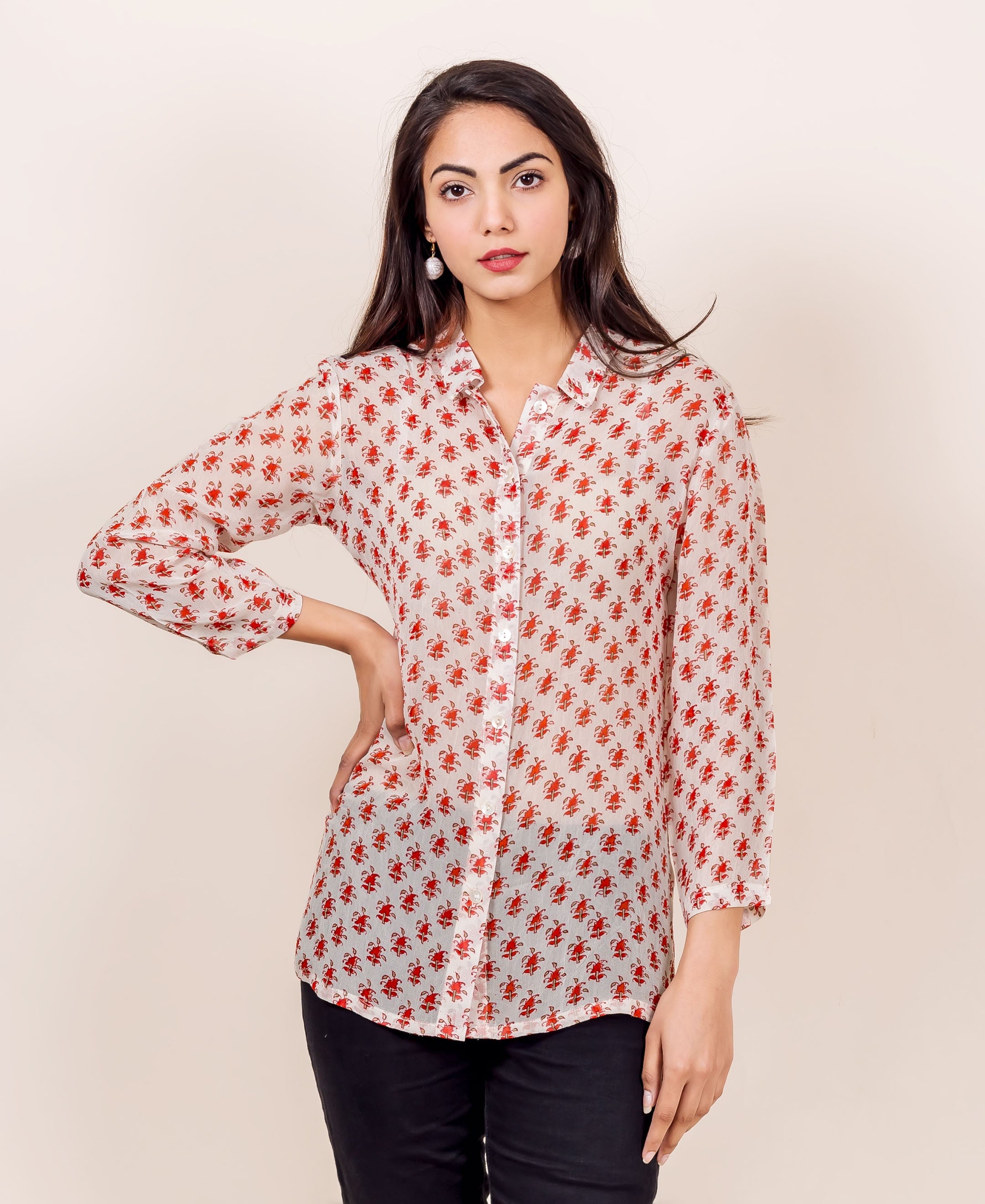 Front view of model in an off-white georgette shirt with small red traditional block print.