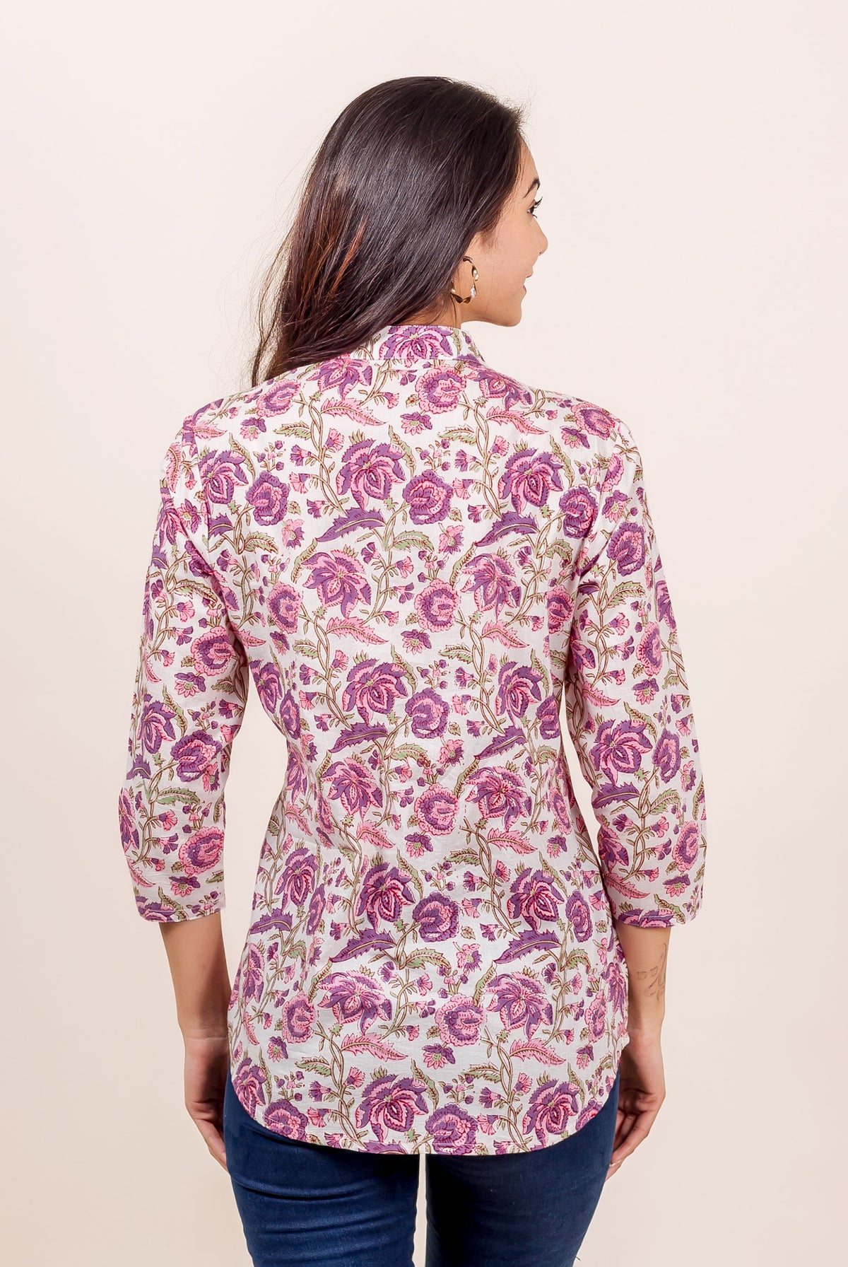 Back view of model wearing a pink and purple hand-block-printed floral ethnic top.