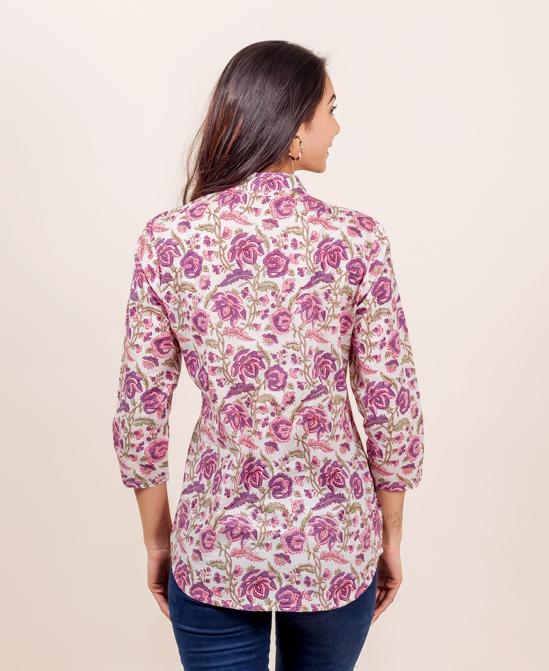 Back view of model wearing a pink and purple hand-block-printed floral ethnic top.