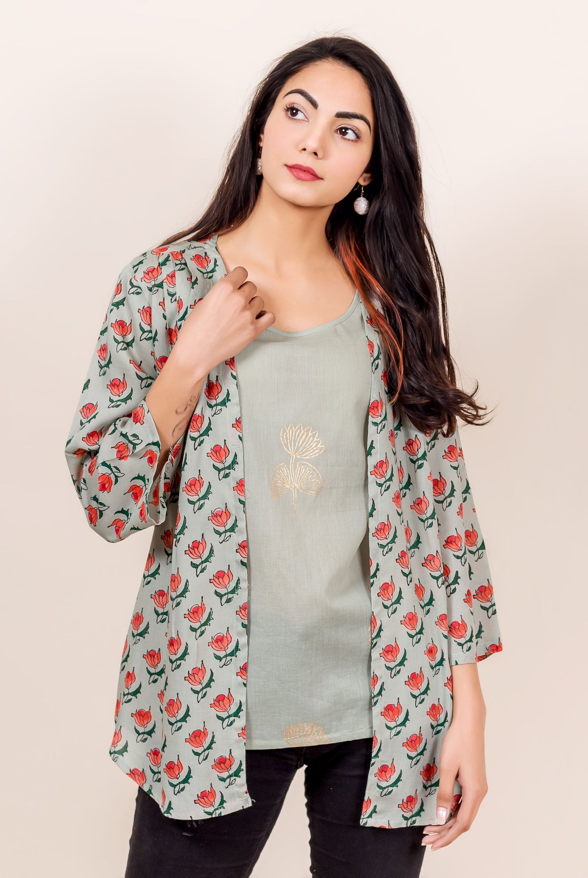 Front view of model wearing grey hand block printed shrug with red flowers.