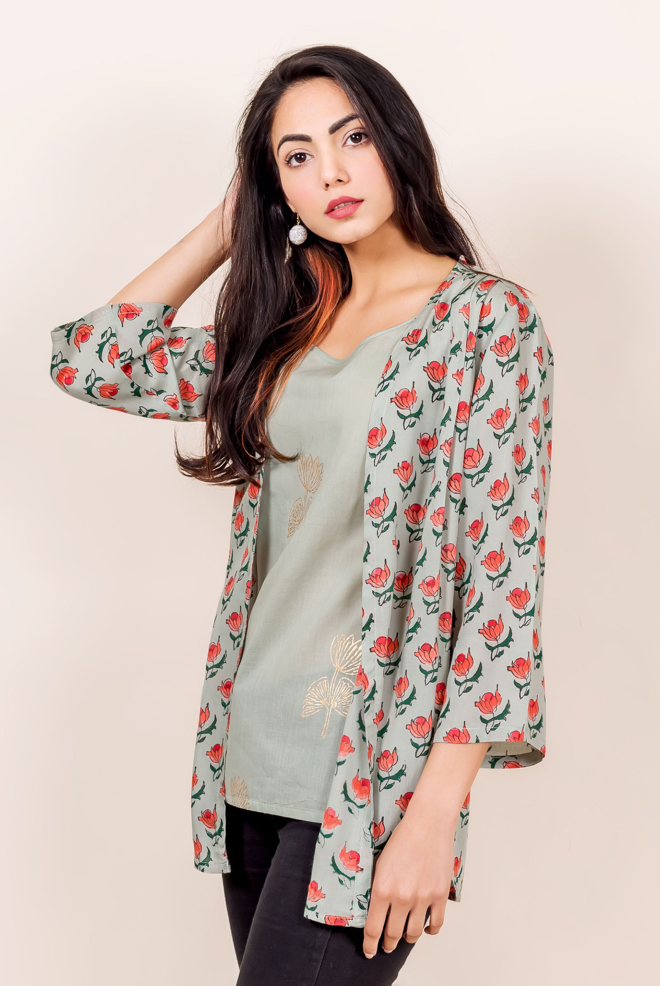 Front view model wearing a light grey hand-block printed shrug with reddish floral motifs.