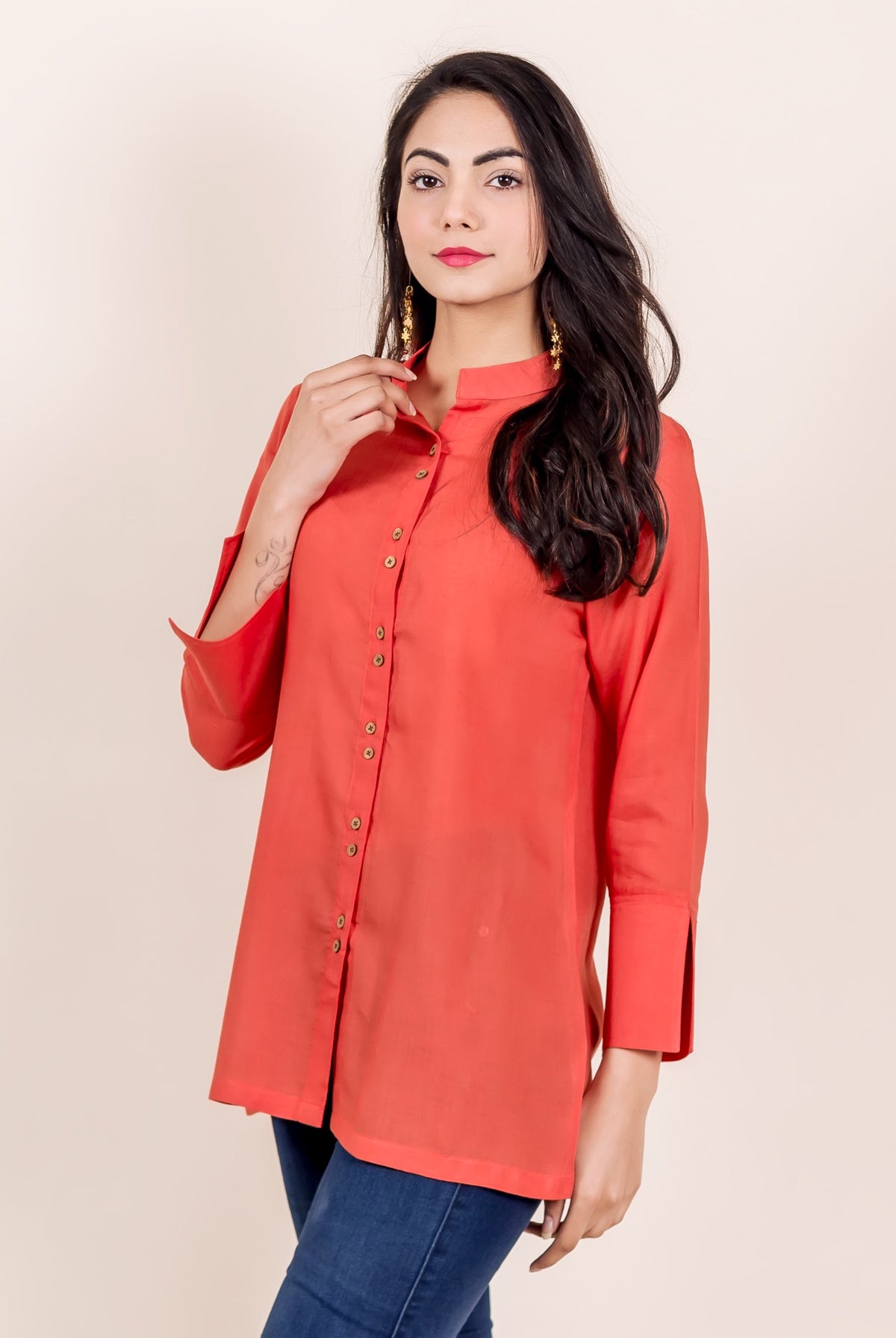 Rust mandarin collar shirt with full button placket and wide cuff sleeves on a model.