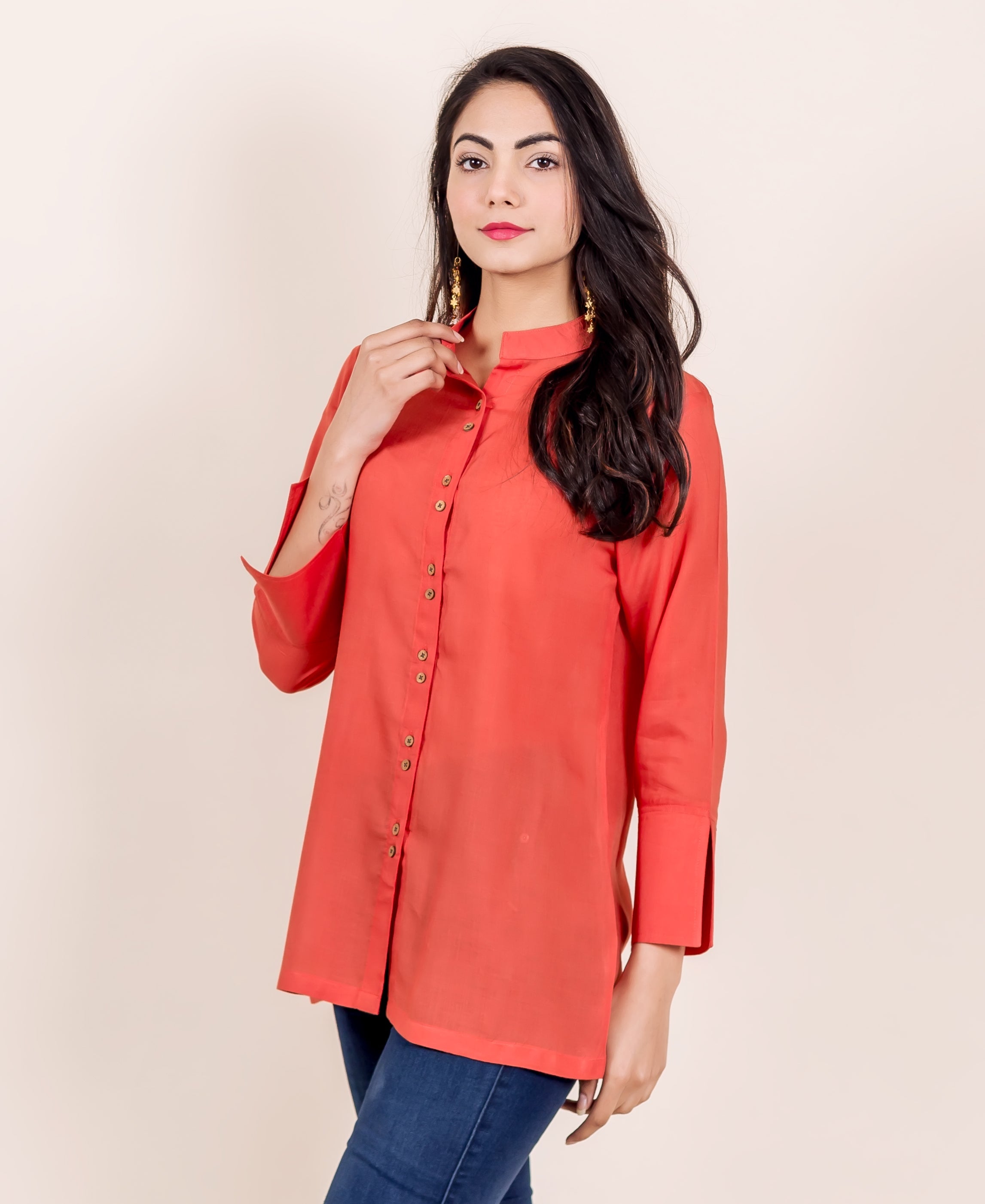 Rust mandarin collar shirt with full button placket and wide cuff sleeves on a model.