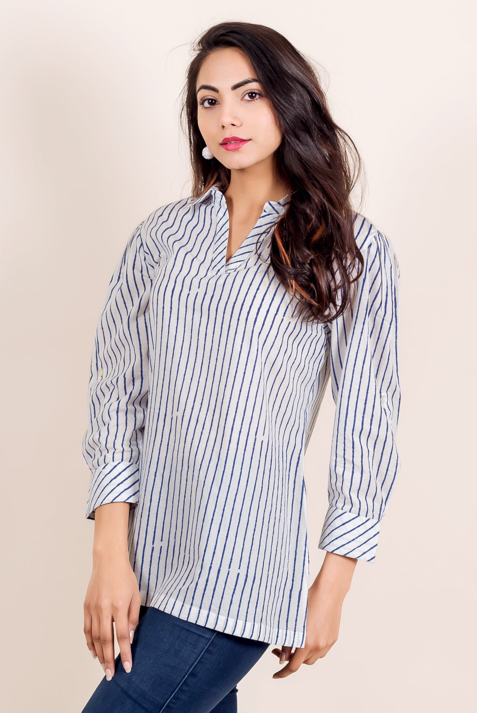 Model in a white and blue hand-block-printed striped shirt top, front view.