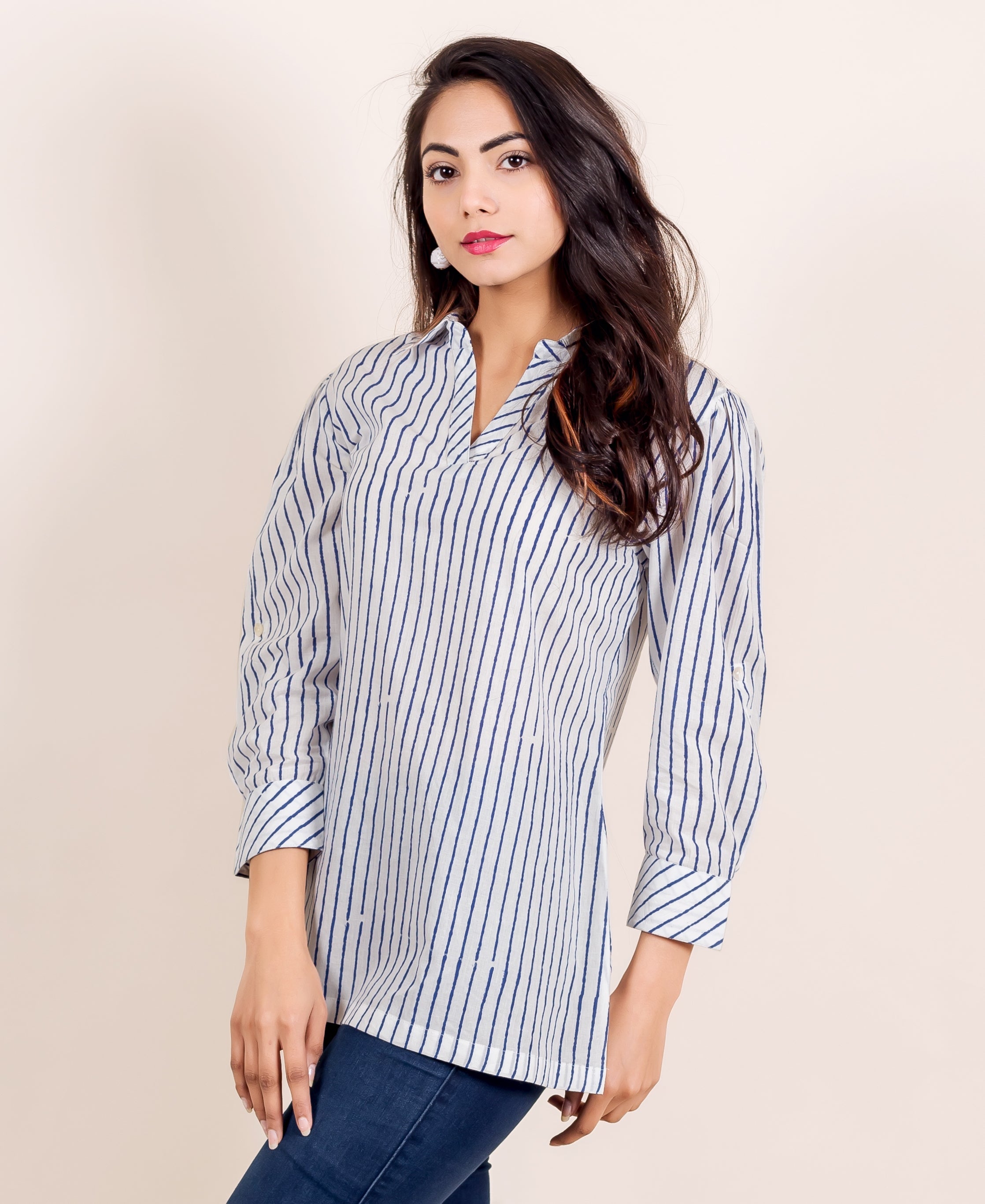 Model in a white and blue hand-block-printed striped shirt top, front view.