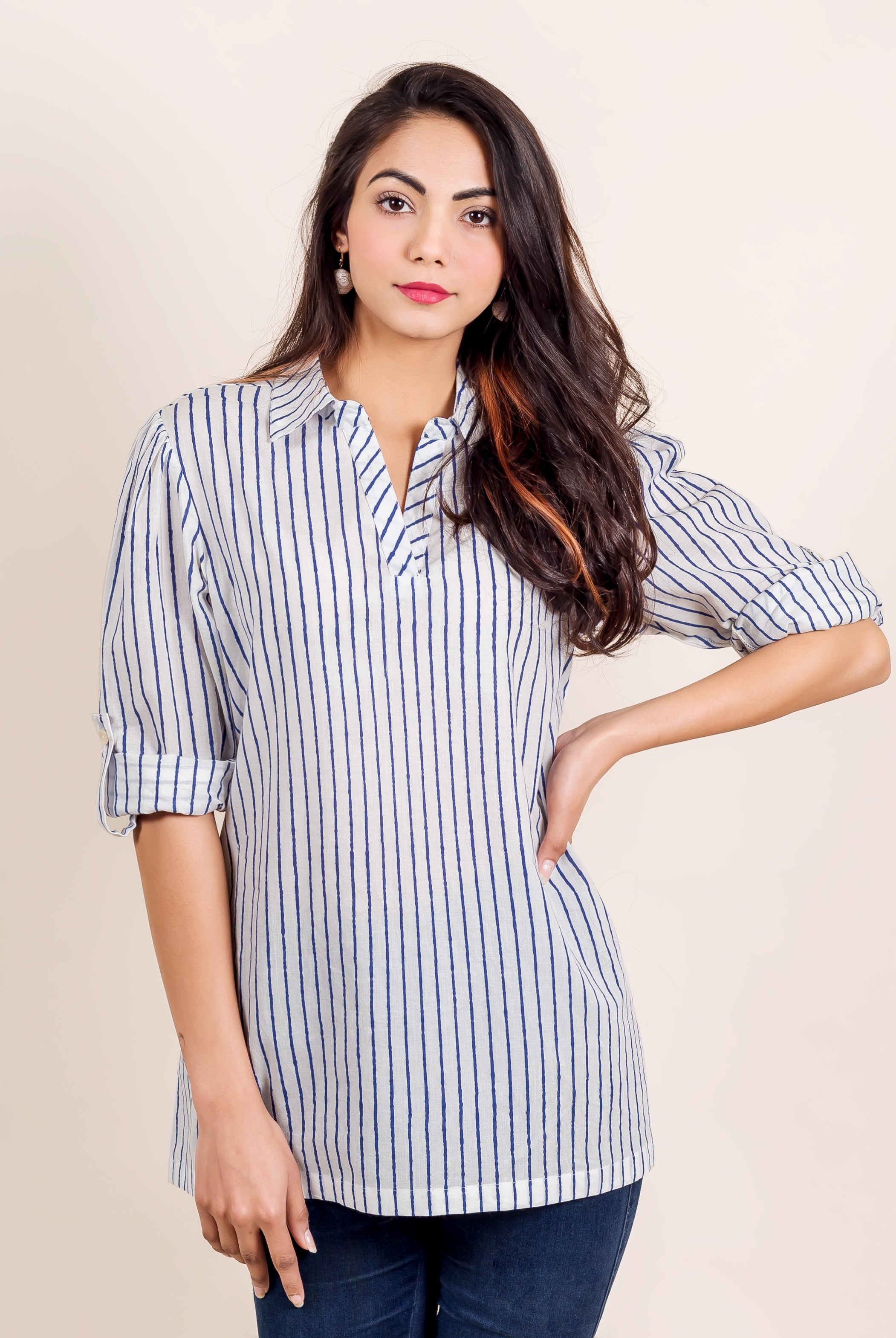 Front-facing model in a white shirt top with slightly uneven vertical blue stripes.
