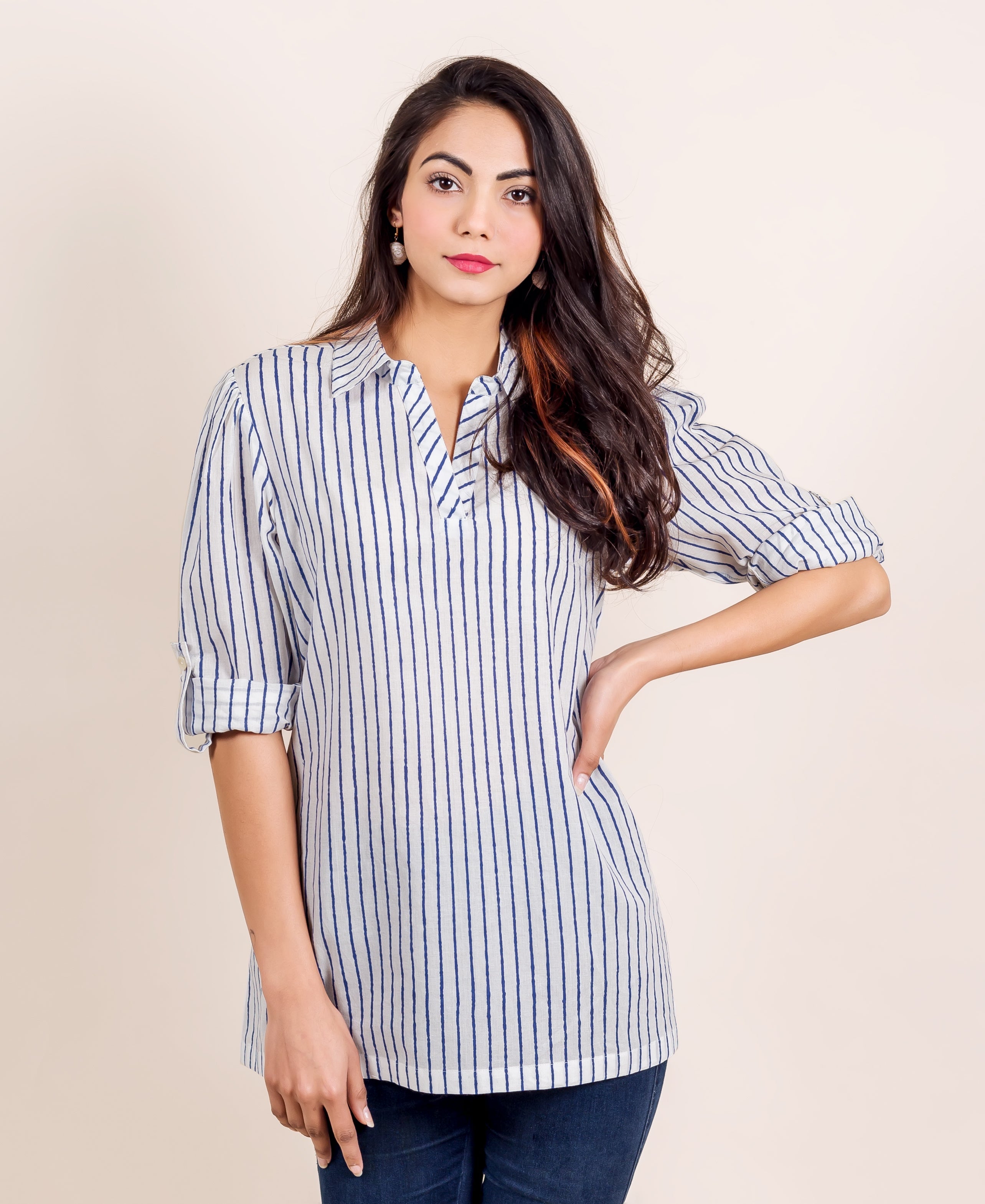 Front-facing model in a white shirt top with slightly uneven vertical blue stripes.