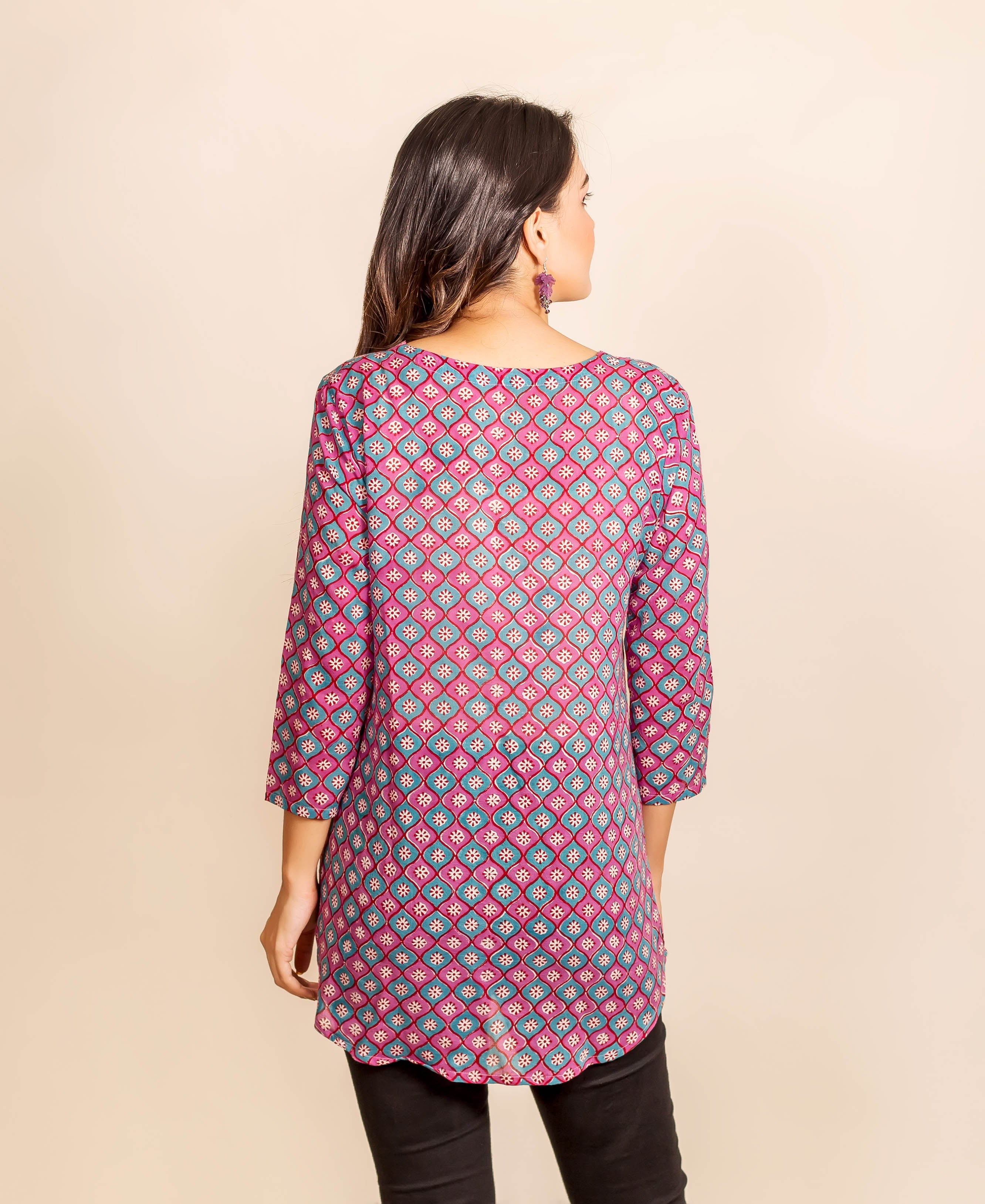 Back view of a model wearing a pink and blue geometric hand-block-printed tunic.