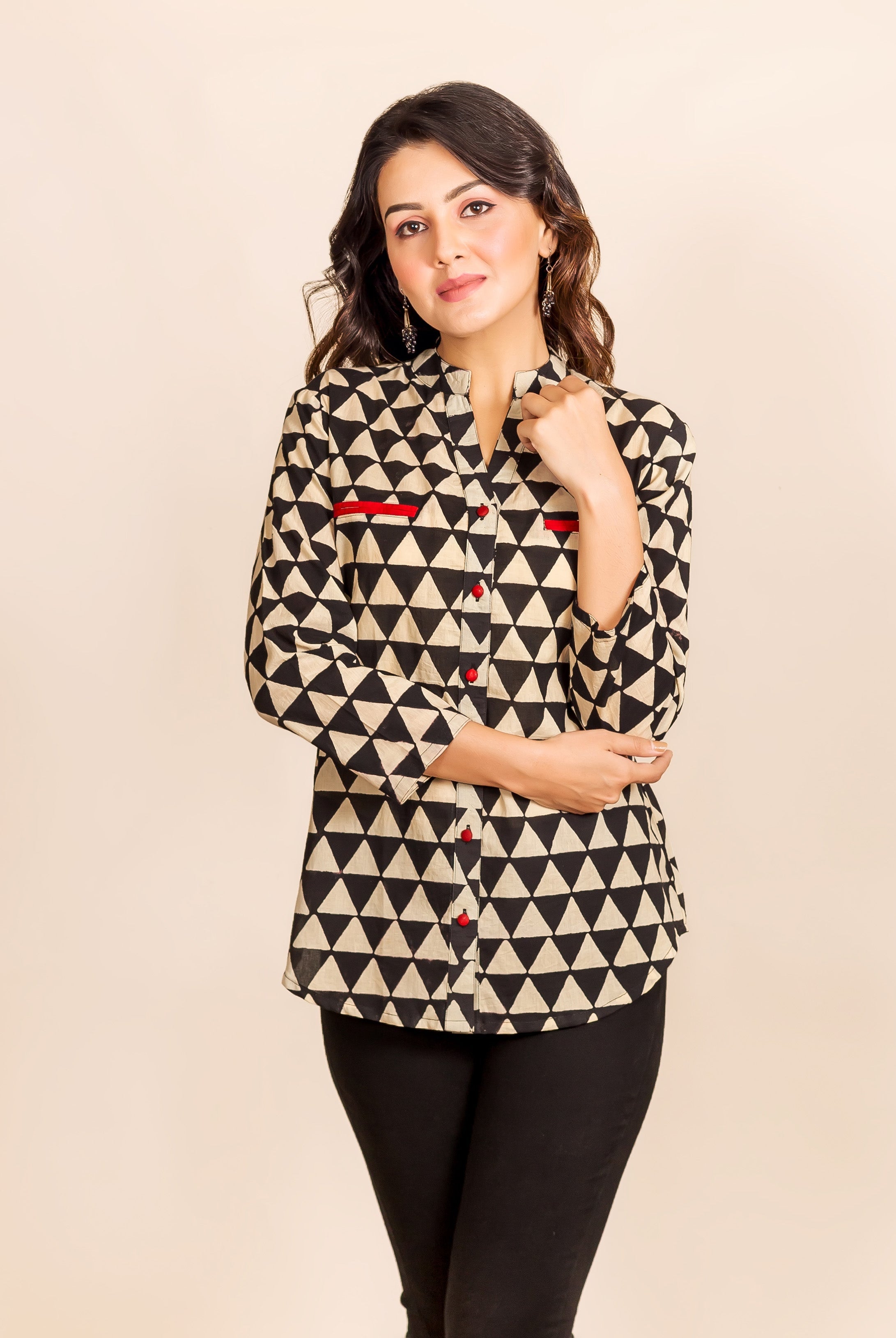 Ethnic black and beige triangle-printed shirt-style top on a model with red accents.