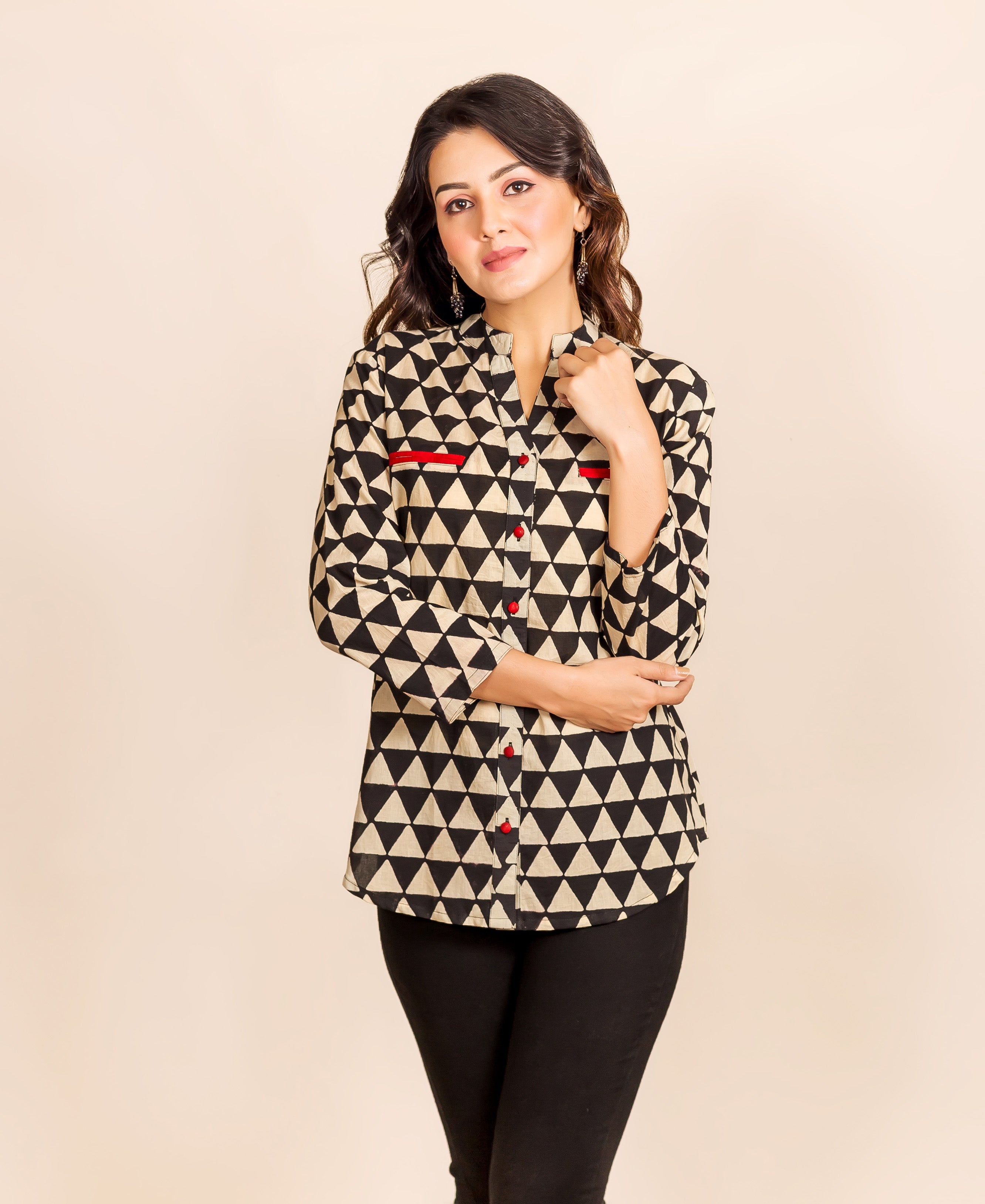 Ethnic black and beige triangle-printed shirt-style top on a model with red accents.