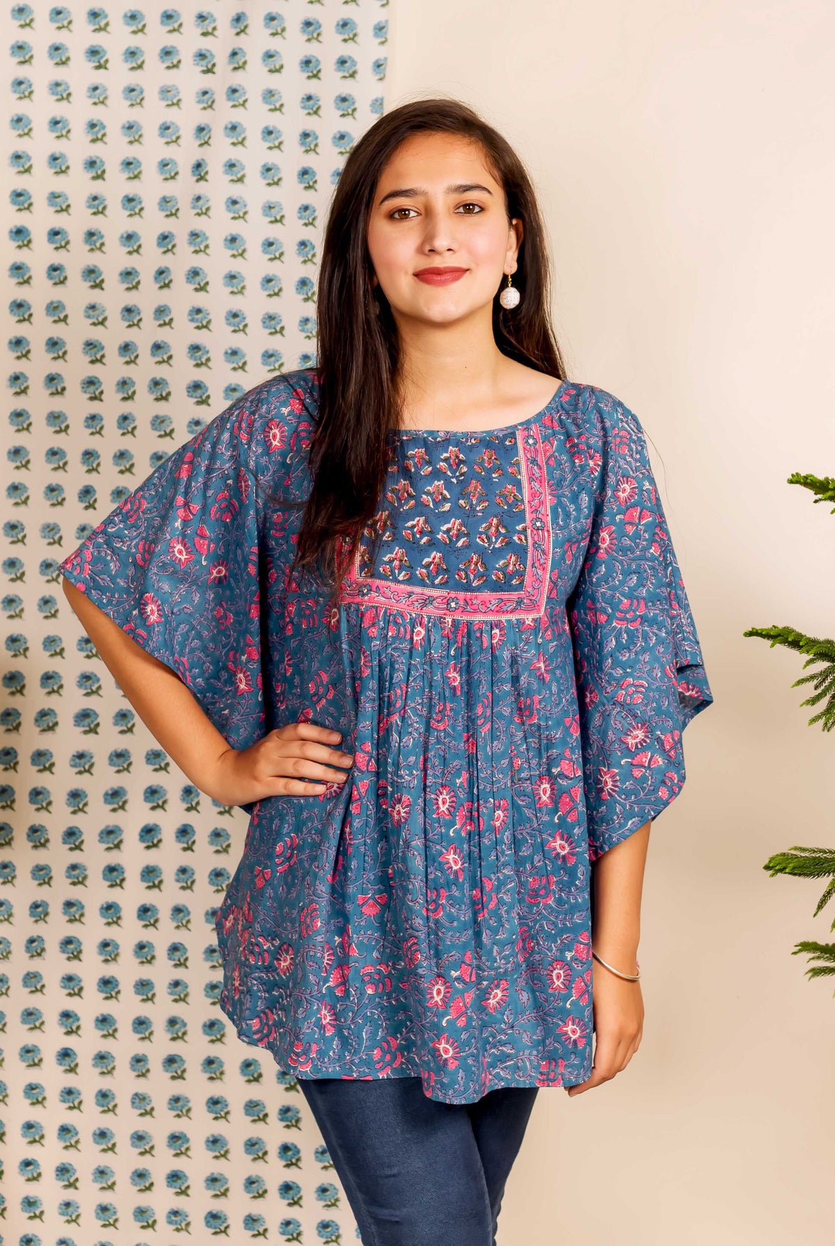 Front view of model in blue and pink hand block printed ethnic floral kaftan top.