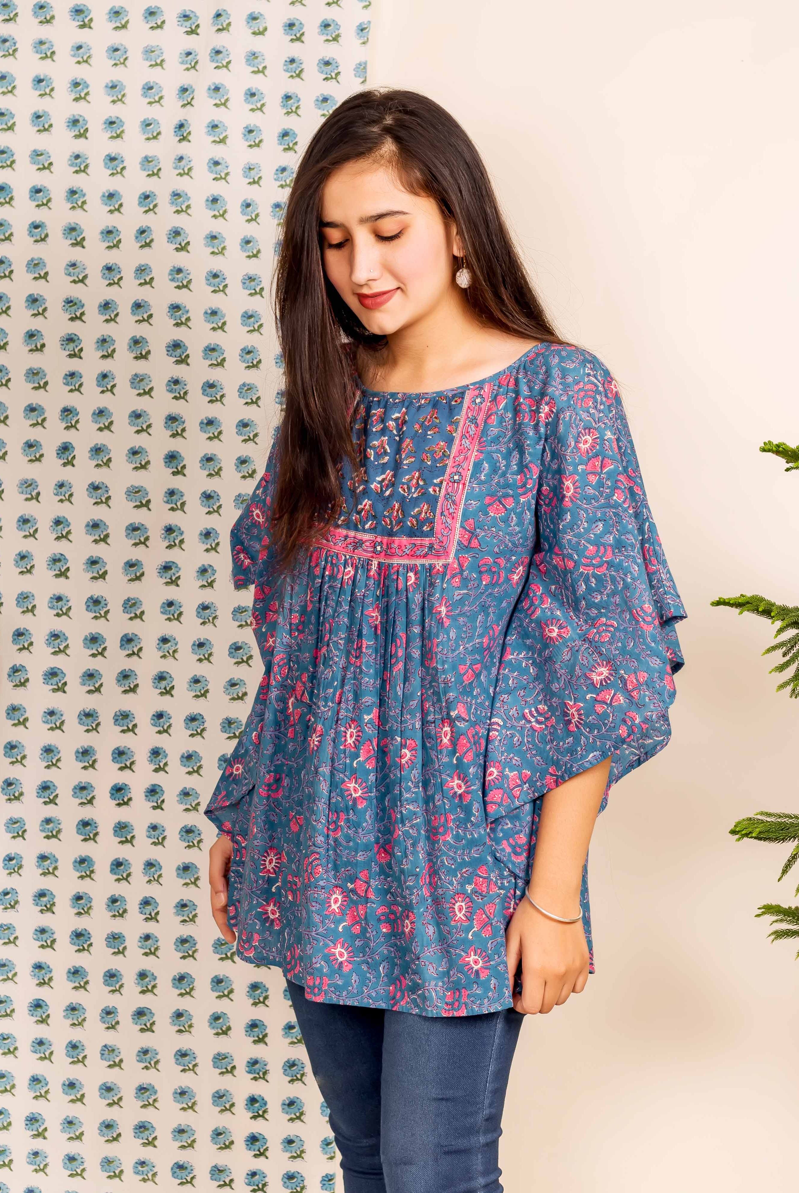 Front view of model wearing blue and pink hand block printed floral kaftan top.