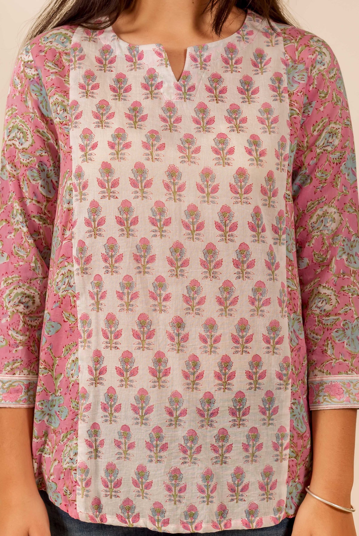 Pink and white floral hand block printed top with three-quarter sleeves and V-neck detail.