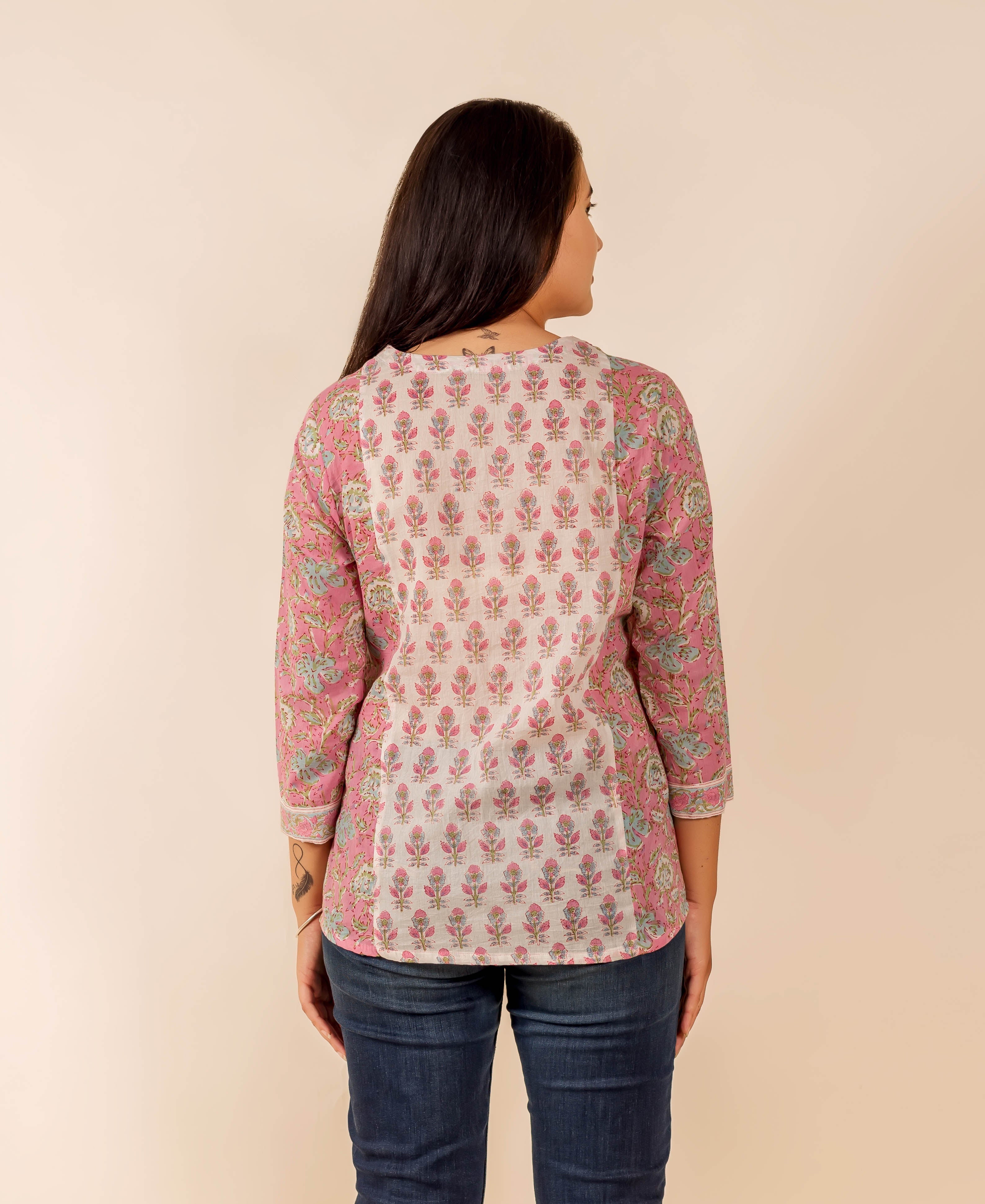 Back view of model in pink and white hand-block printed floral top.