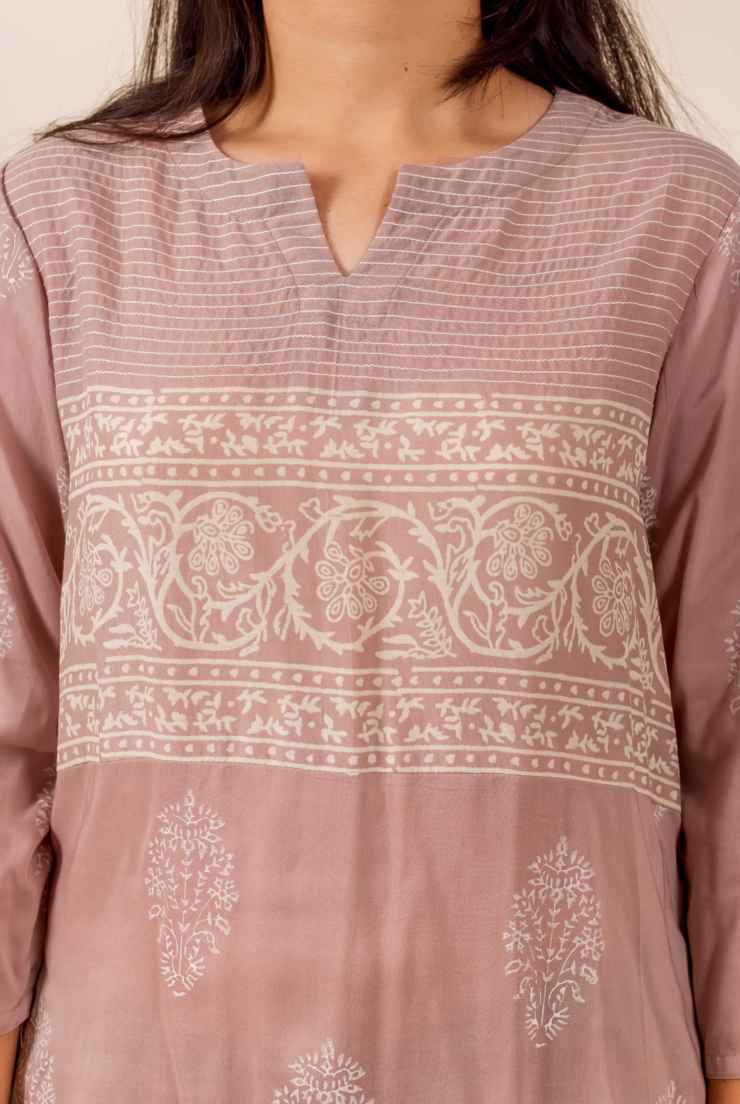 Dusty pink hand-block printed top on a model with white floral patterns and thread work.