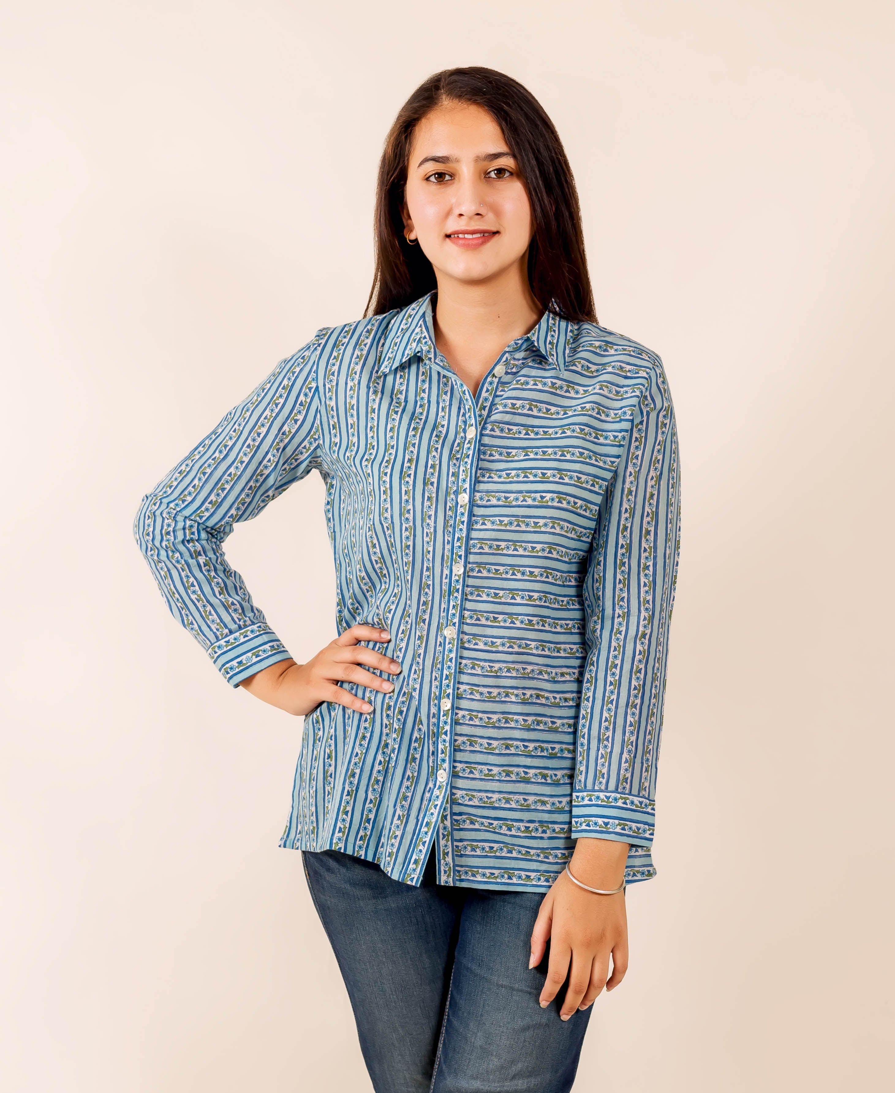 Smiling model in blue hand block printed button-down shirt and jeans, showing striped pattern.