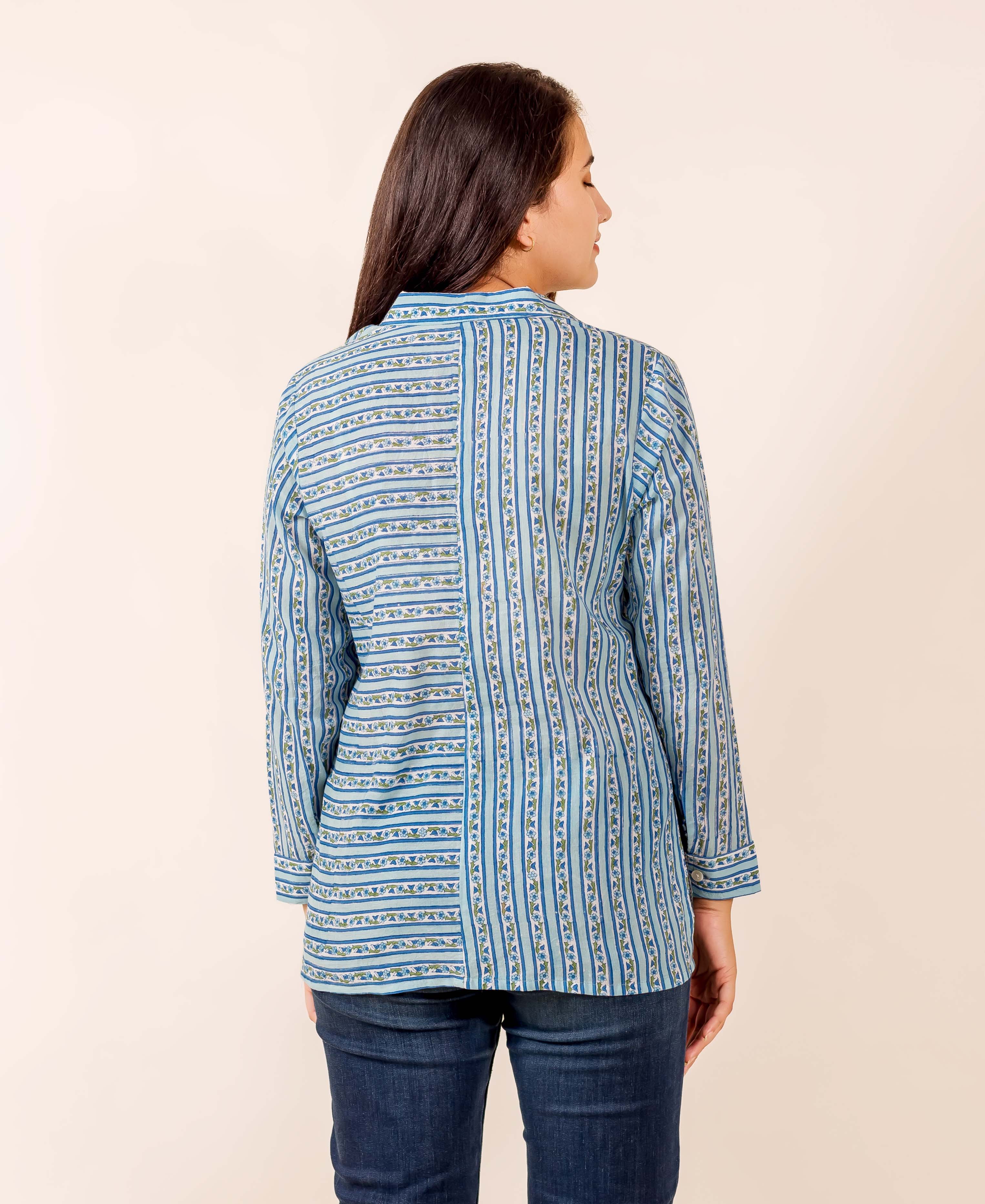 Model's back, blue hand-block printed button-down shirt with mixed horizontal and vertical stripes.