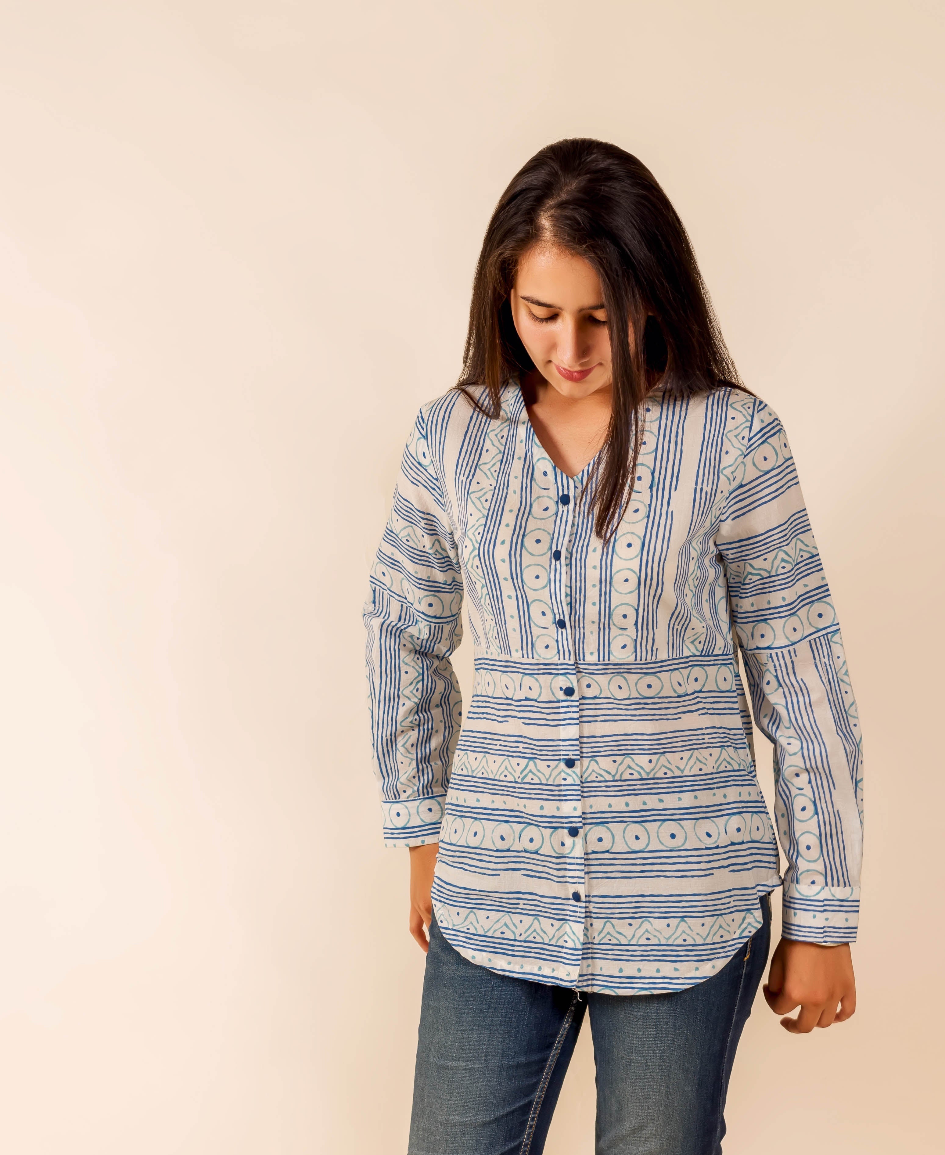 Model in a white and blue hand-block-printed ethnic long-sleeved shirt with varied patterns.