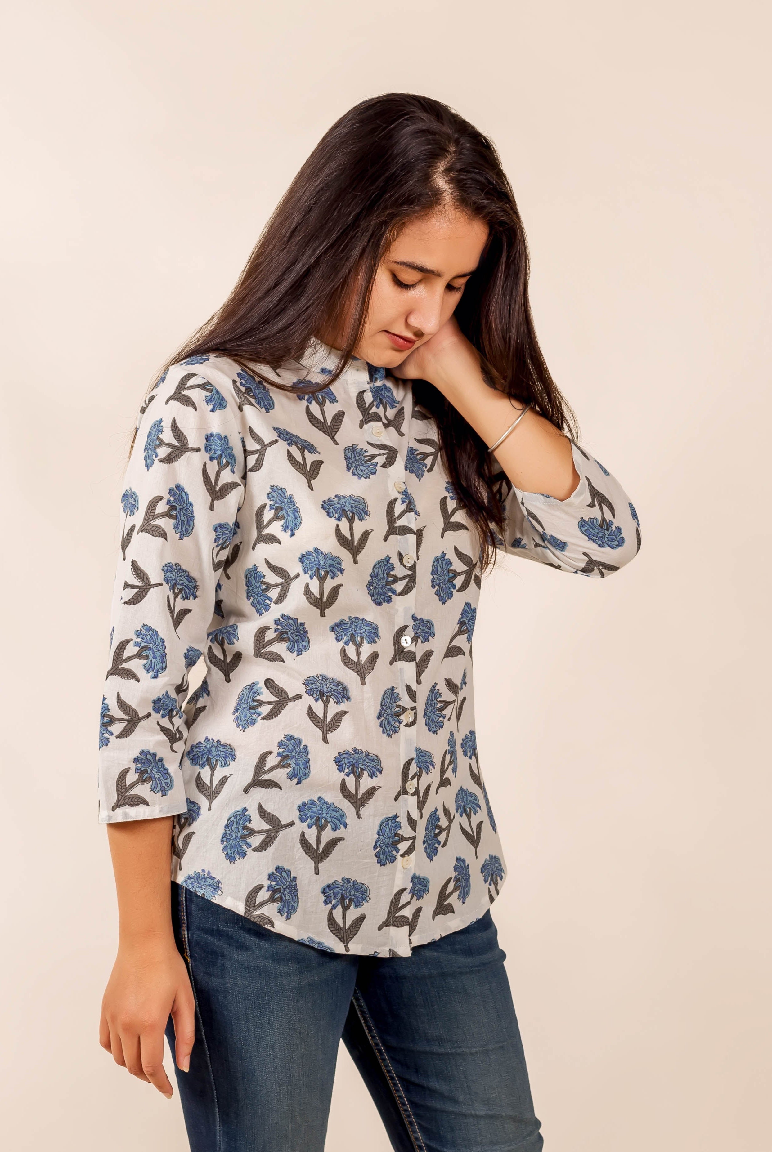Model in a white and blue floral hand-block-printed top with three-quarter sleeves.
