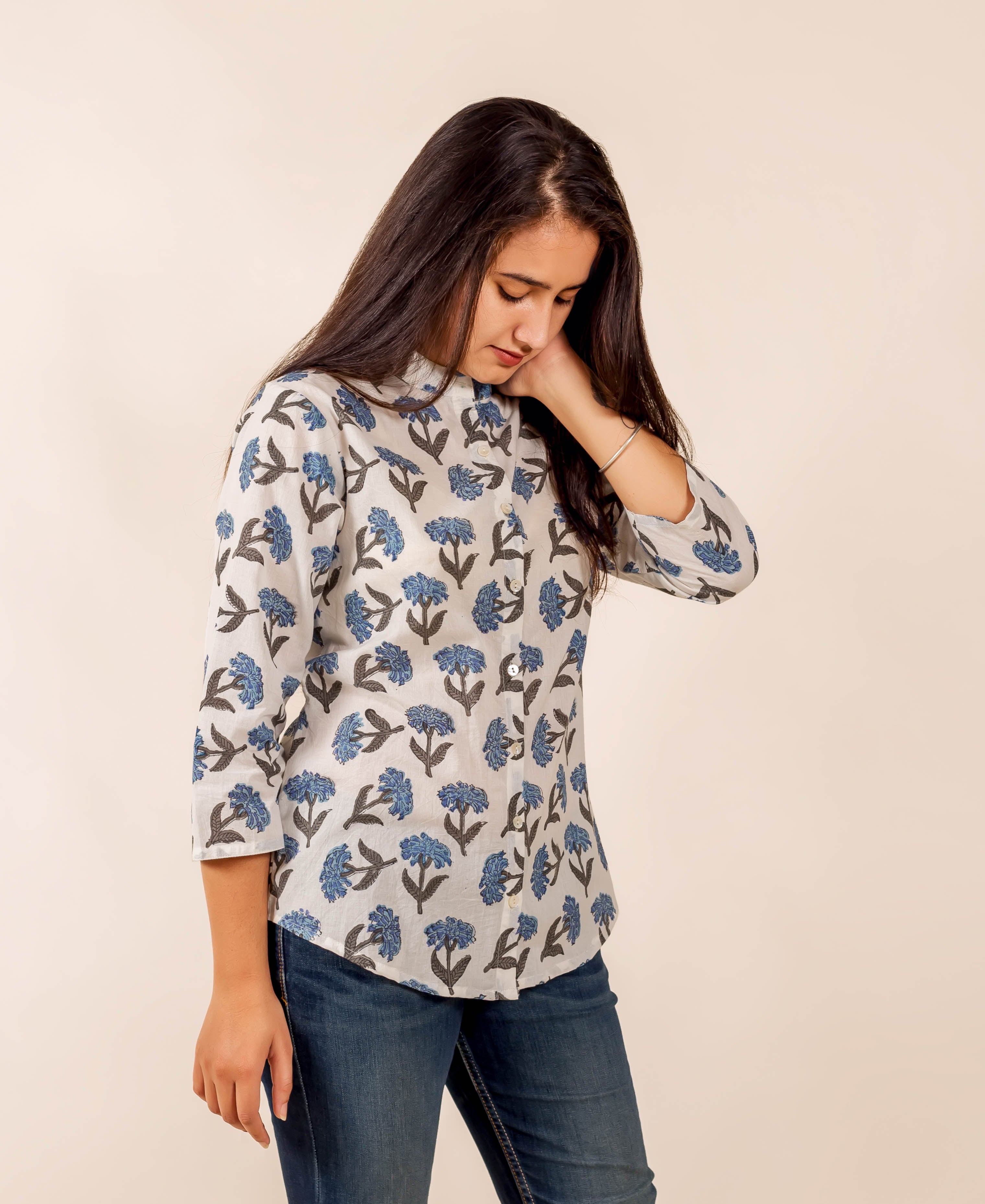 Model in a white and blue floral hand-block-printed top with three-quarter sleeves.