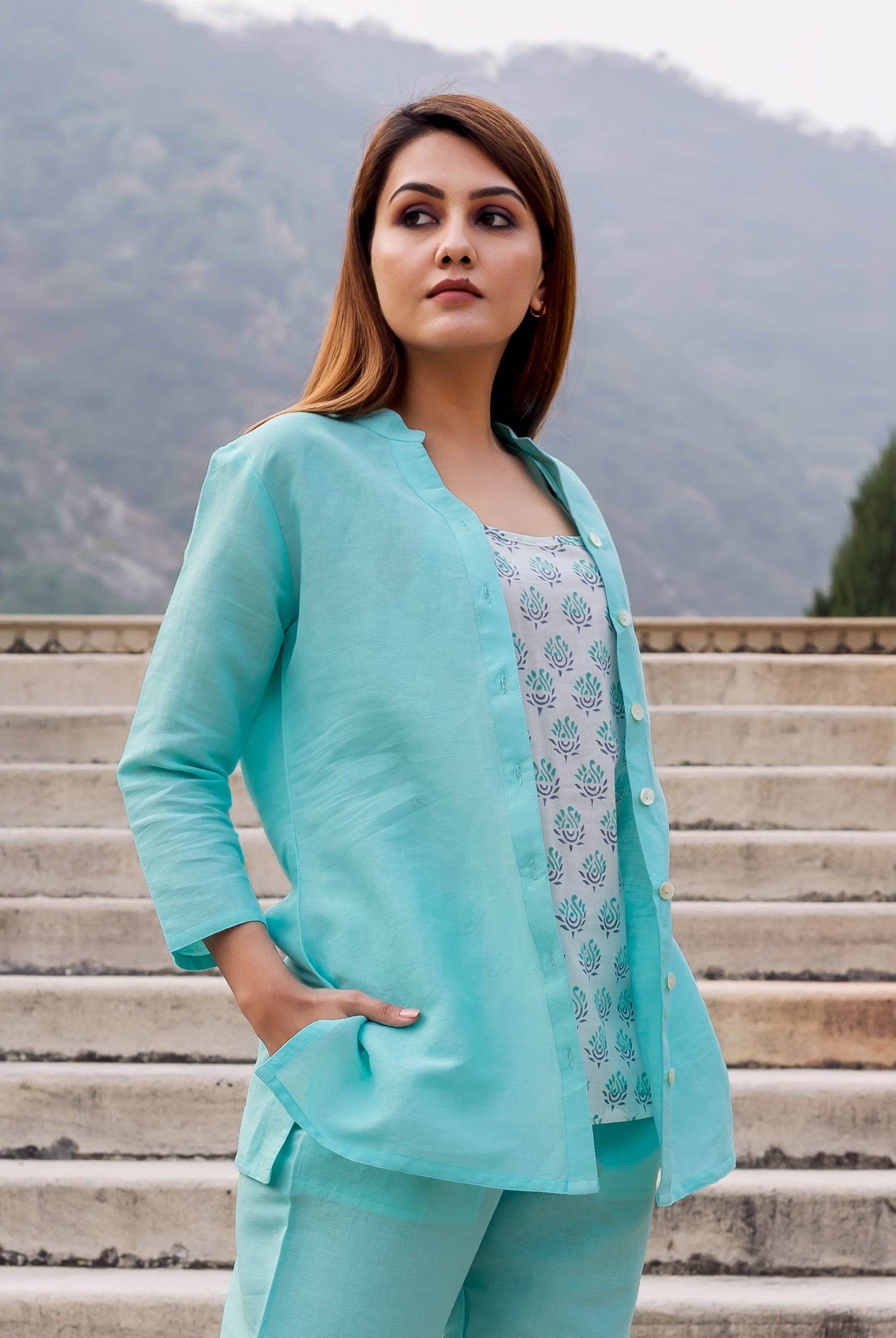 Model wears baby blue linen top over white hand-block-printed inner, matching pants, full look.