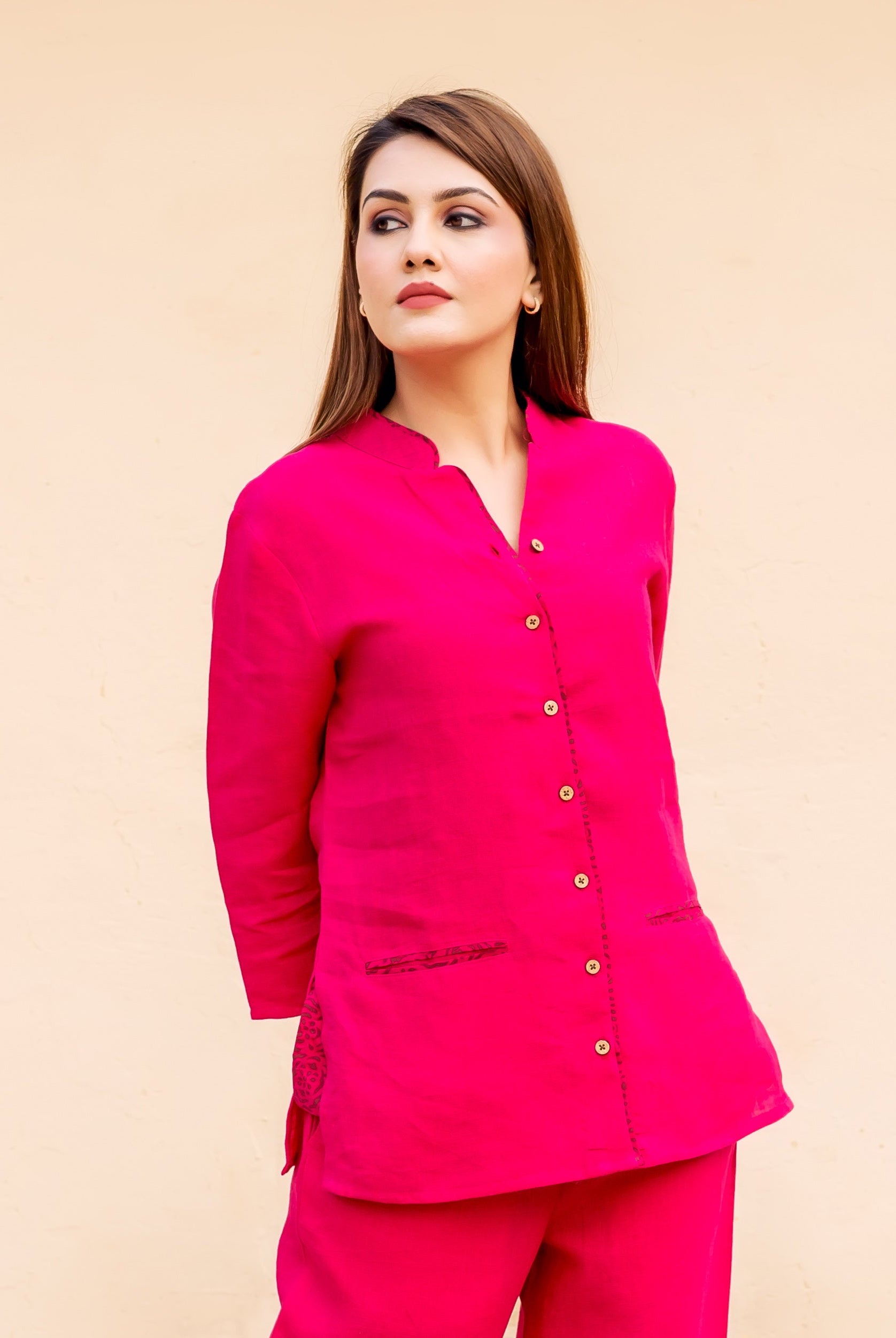 Ruby pink top on model, front-side, with dark patterned pocket and side accents.