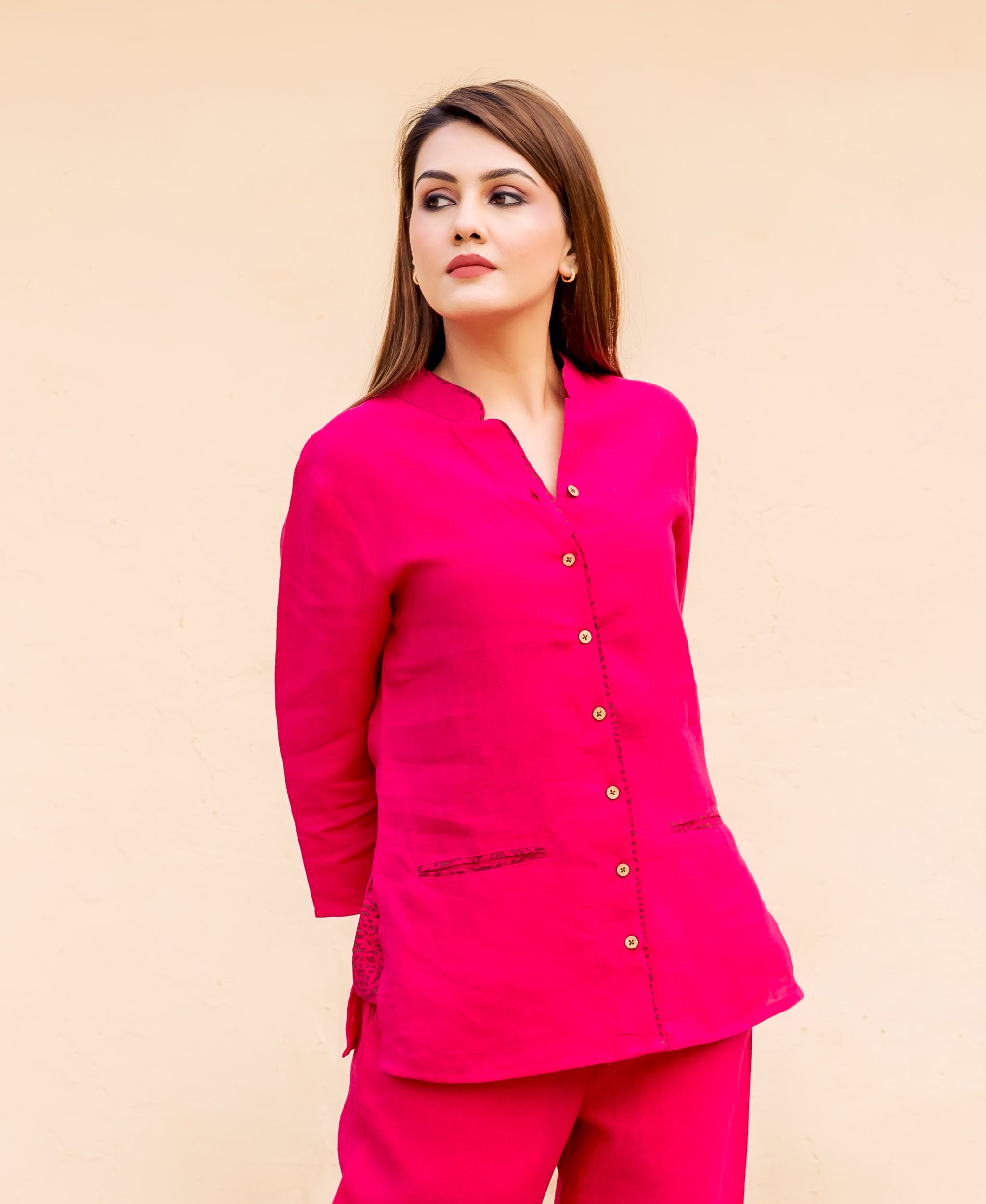Ruby pink top on model, front-side, with dark patterned pocket and side accents.