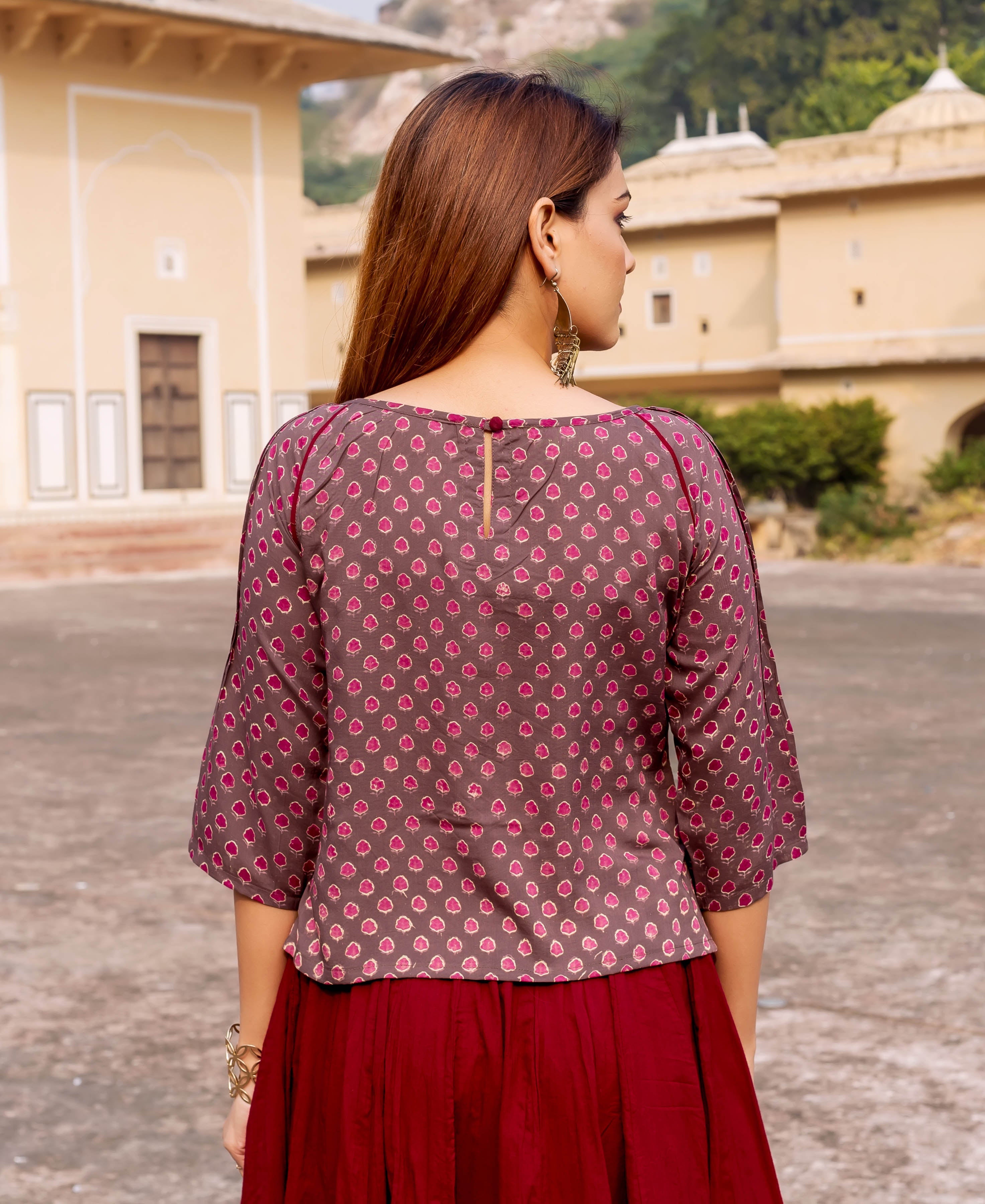 Brown hand block printed top with pink floral pattern, worn by a model.