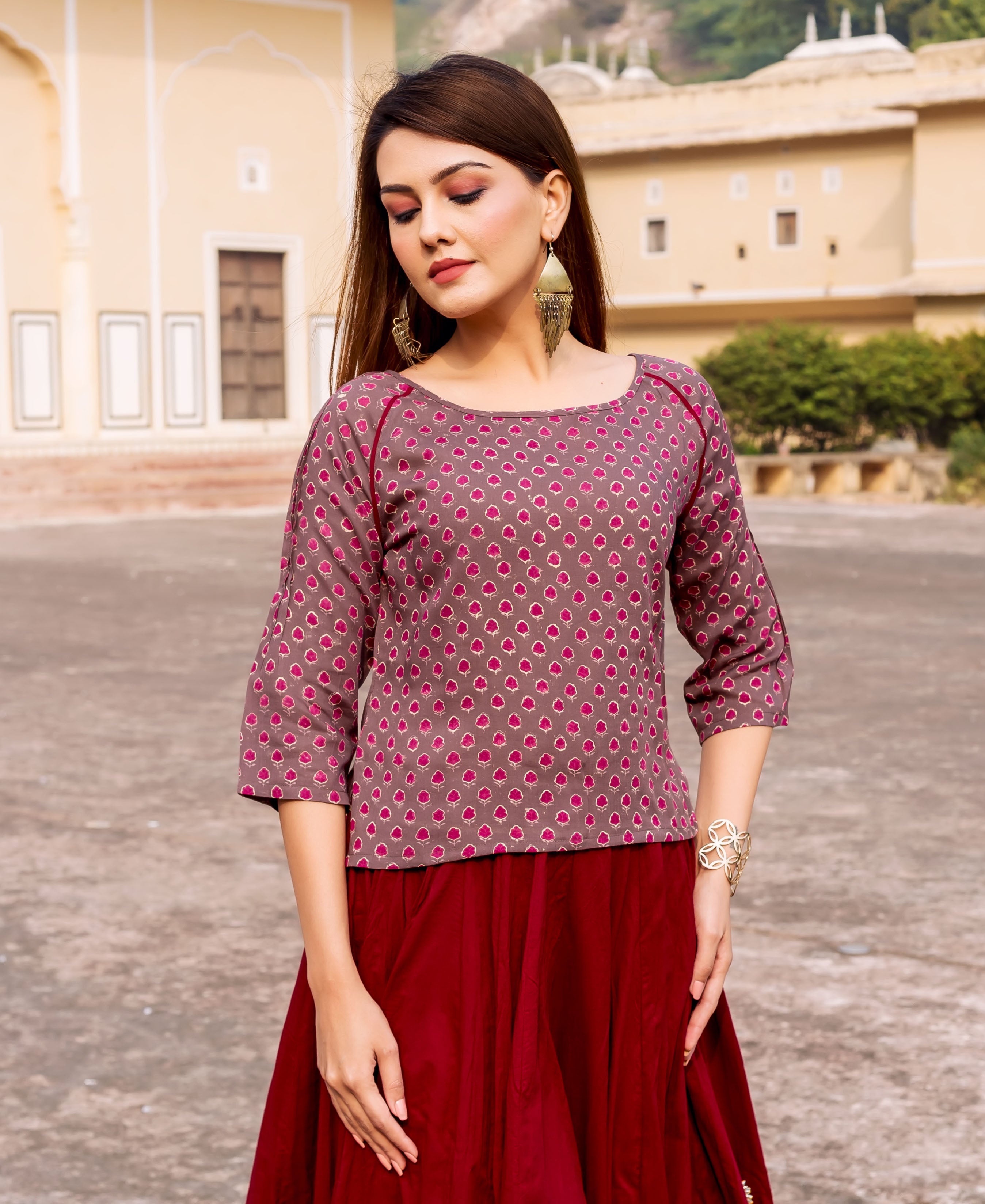 Brown hand-block-printed top with pink floral pattern, worn by a model.